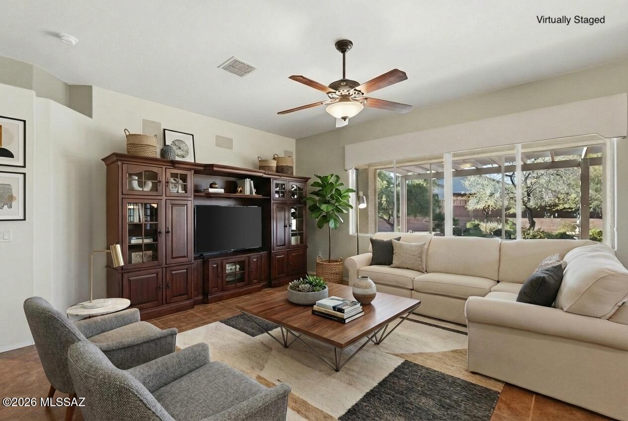 Set within the desirable Las Campanas community, this impeccably maintained residence offers a rare blend of privacy, space, and serene desert beauty. Thoughtfully set back from the road, the home welcomes you through a charming, enclosed paved courtyard—an inviting introduction to the comfort and refinement found within.

Soaring ceilings and an open-concept living and dining area create an immediate sense of volume, making the home feel far more expansive than its footprint suggests. The light-filled living room overlooks a truly picturesque backyard, offering a seamless connection to the outdoors. Just off the main living area, a well-positioned den or office provides a flexible space ideal for work, reading, or quiet retreat. The kitchen is both functional and stylish, featuring stainless steel appliances, granite countertops, a custom tile backsplash, and a reverse osmosis system. Beyond the kitchen, the laundry room leads to an additional versatile spaceperfect for extra storage, a hobby room, or creative pursuits. The extended garage is equally well appointed, complete with abundant cabinetry for exceptional organization.

An enclosed Arizona room off the living area invites year-round enjoyment of the backyarda lush, park-like setting rarely found in Las Campanas and truly reminiscent of having your own private oasis.

The primary suite is a peaceful retreat, highlighted by bay windows with tranquil views, dual closets, and an en-suite bath with separate vanities. A guest bedroom located down the hall offers bay windows overlooking the front courtyard and captures scenic views of the Santa Rita Mountains.

With its thoughtful layout, exceptional outdoor spaces, and meticulous care throughout, this home stands apartoffering a lifestyle that is as refined as it is inviting.