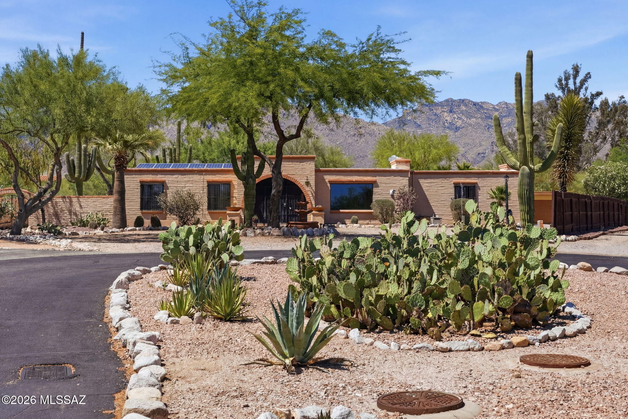 Nestled on a premium view lot in a scenic foothills cul-de-sac, this exceptional desert retreat offers the perfect blend of luxury, comfort, and functionality. Featuring an owned solar system, sparkling pool, relaxing hot tub, putting green, and a versatile heated/cooled exterior studio with mini split, this home is designed for both entertaining and everyday living.

Inside, timeless character shines through with dual fireplaces, custom built-ins, and expansive picture windows framing breathtaking mountain and city light views. The spacious family room offers warmth and charm, while the formal living and dining areas create an inviting atmosphere for gatherings.