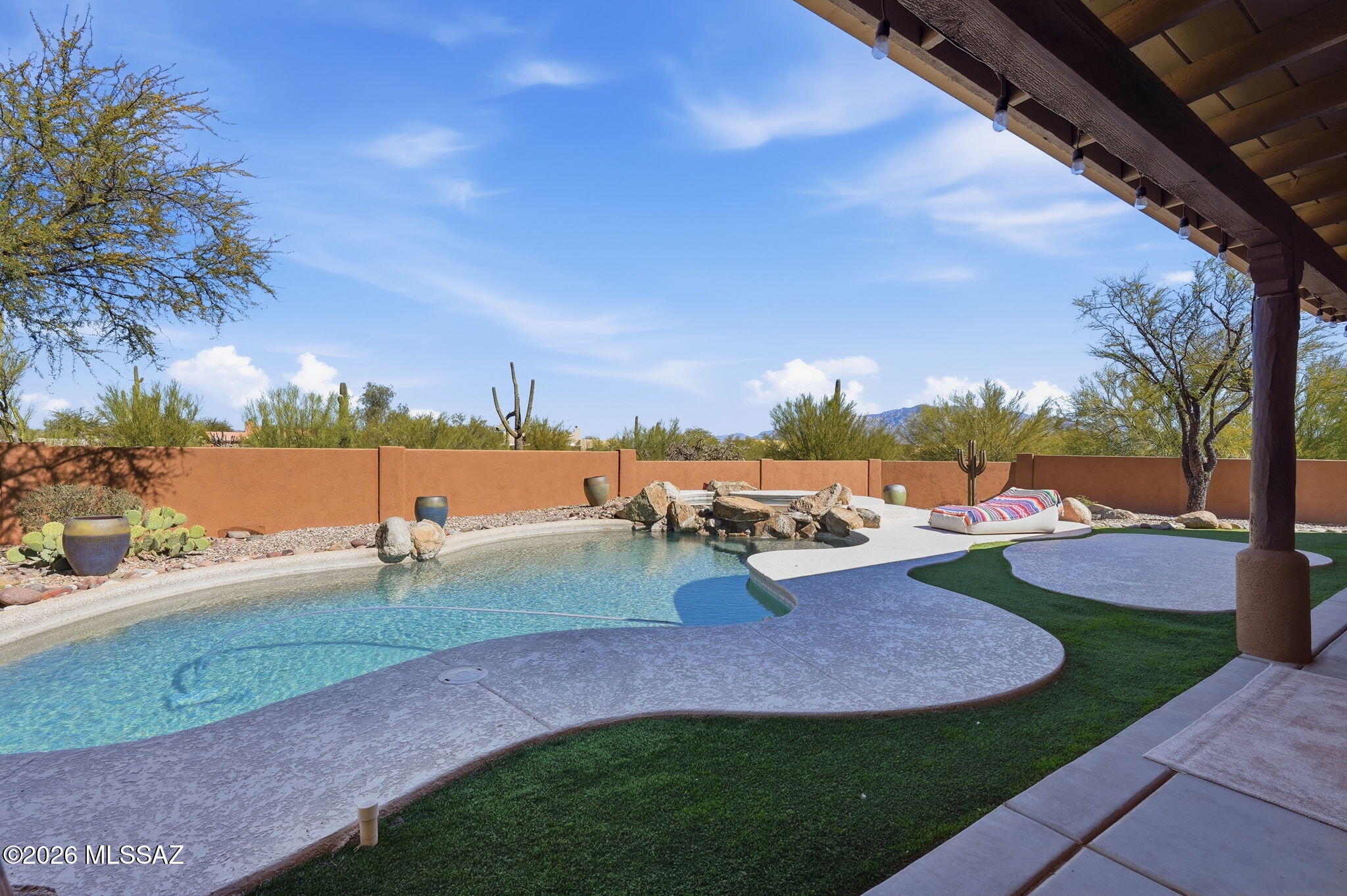 Gorgeous updated custom Santa Fe style home in desirable gated community. Great room floorplan w/high ceilings, lots of natural light. Beautiful wood-look plank floors. Updated kitchen w/granite counters, tile backsplash, stainless appliances and beautiful dark walnut wood breakfast bar w/wood beams. Large primary retreat w/updated bath featuring granite countertop, custom Koehler rain glass walk-in shower & fixtures 2020. New Trane 2016. Entire interior/exterior painted 2020. Enjoy relaxing or entertaining in your amazing private backyard resort-style oasis that features a pebble tec pool, spa & cantina w/outdoor kitchen & BBQ. Open space behind provides privacy, beautiful Catalina Mountain views. Most furniture can stay with the sale.