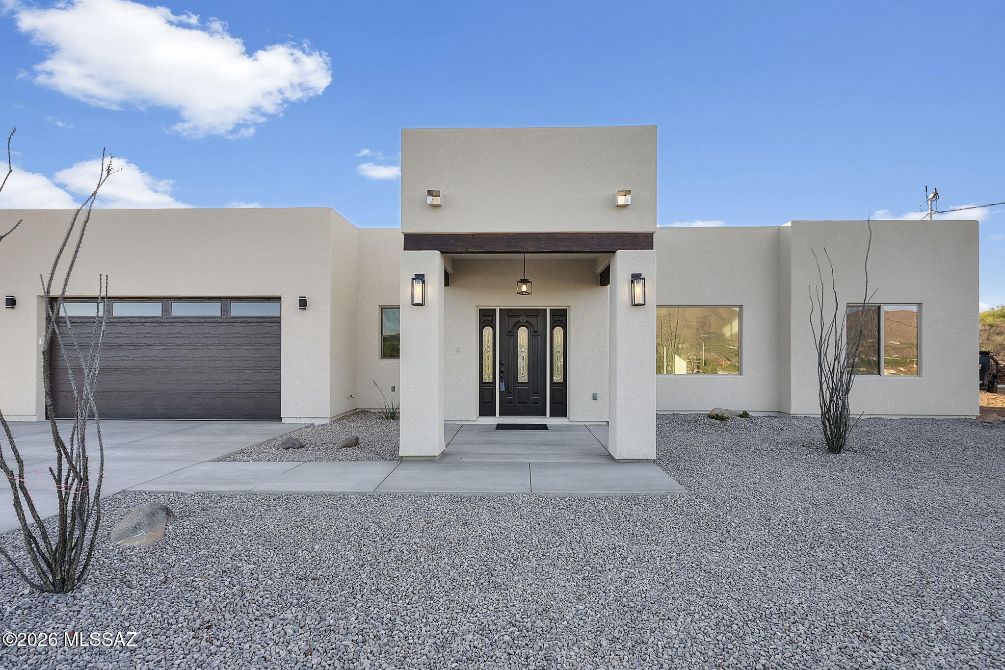 Brand new custom home situated on nearly half an acre, offering exceptional quality and design. Thoughtfully built with superior craftsmanship, this home stands out from the typical construction in the area. Step through a sophisticated entryway into an open, light-filled living space highlighted by oversized picture windows that frame breathtaking mountain views. The heart of the home is a stunning 9-foot kitchen island perfect for gathering with family and friends complete with a built-in beverage cooler, 42-inch wood cabinetry and higher-end appliances that elevate both style and functionality. The spacious laundry room even turns everyday tasks into a pleasure, featuring a large picture window with beautiful mountain views. Retreat to the spa-inspired owner's suite, where a gorgeous walk-in shower creates a relaxing, luxurious atmosphere. Outside, enjoy the extended covered back patio--ideal for taking in the peaceful surroundings and spectacular mountain scenery. Built with quality and attention to detail throughout. Soaring ceilings, massive living room, huge windows, mountain views, insulated bedroom walls and garage, beautiful front door. This home has it all.
