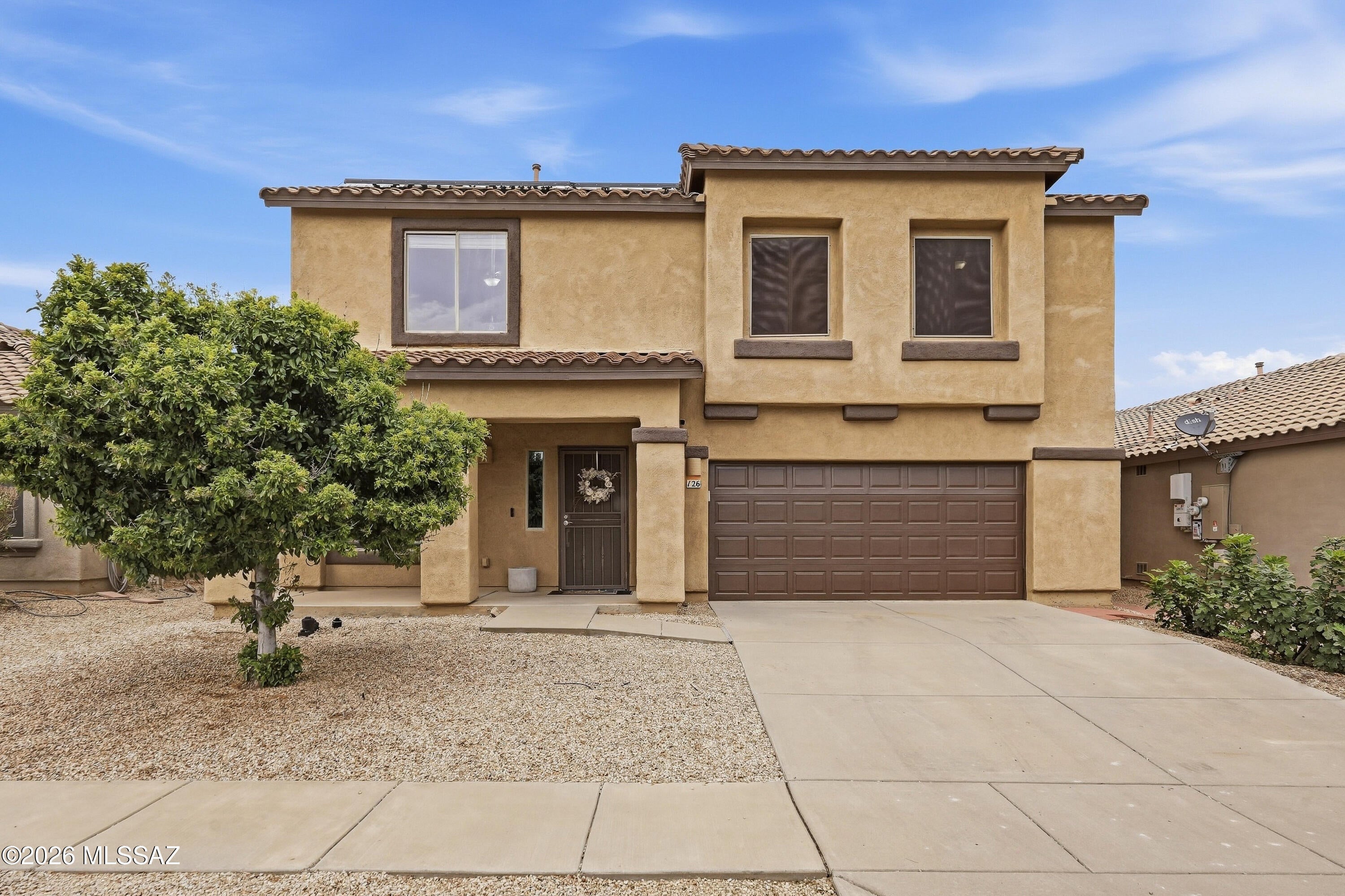 Welcome to Rancho Sahuarita! This move-in-ready home offers over 2,500 sq. ft. of living space, starting with a formal living room that could also be your home office or playroom. The open kitchen connects to the dining area and family room, where a cozy gas fireplace makes it easy to gather. You'll also find a convenient half bath downstairs. The kitchen features a gas range, farmhouse sink, maple cabinets, breakfast bar, and generous pantry. A new HVAC system adds comfort year-round. 

Upstairs, there's room for everyone with 4bedrooms, a spacious loft, a built-in desk area for work or homework, and a large laundry room. The primary suite features a walk-in closet, dual vanities, a walk-in shower, and a generous private balcony where you can take in the sunset. Durable vinyl plank flooring extends up the stairs and throughout the second floor. 

With no rear neighbors, the backyard offers a full-length covered patio and plenty of space to relax or entertain. Window coverings, solar screens, leased solar, and a pre-plumbed soft-water loop add to the home's appeal. 

Enjoy Rancho Sahuarita's lake, clubhouse, fitness center, pools, splash pad, parks, and walking trails, with a neighborhood park and community pool just around the corner!