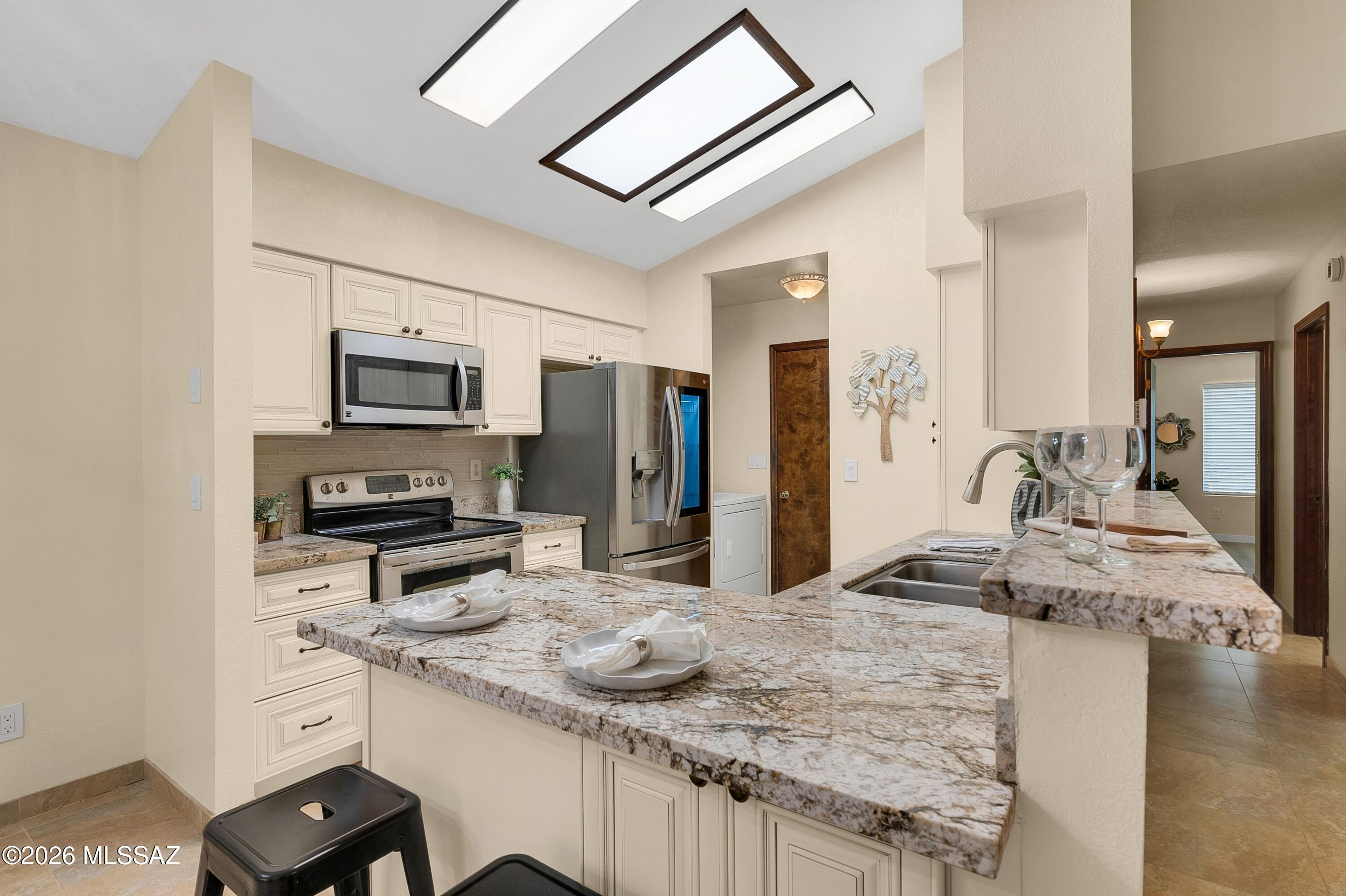 Tucked away in Hobby Horse Ranch, this updated 4BD/2BA home offers a split-bedroom floor plan, flexible living spaces & thoughtful upgrades throughout. Conveniently located near shopping, dining, everyday amenities & I-10, while enjoying an established neighborhood with community pool, spa & cabana. The light-filled great room features newer LVP flooring, vaulted ceilings, skylights, fireplace, newer HVAC & ceiling fans. Updated kitchen offers cream cabinetry with soft-close hinges, granite counters, pull-out shelving & SS appliances incl LG InstaView French Door refrigerator. Finished Arizona Room provides versatile space for entertaining, fitness, hobbies or work. Spacious primary suite includes a walk-in closet & updated bath with roll-in shower. Lush backyard oasis with paver patio, gazebo, citrus trees & abundant shade. Move-in ready with exceptional storage & flexibility.