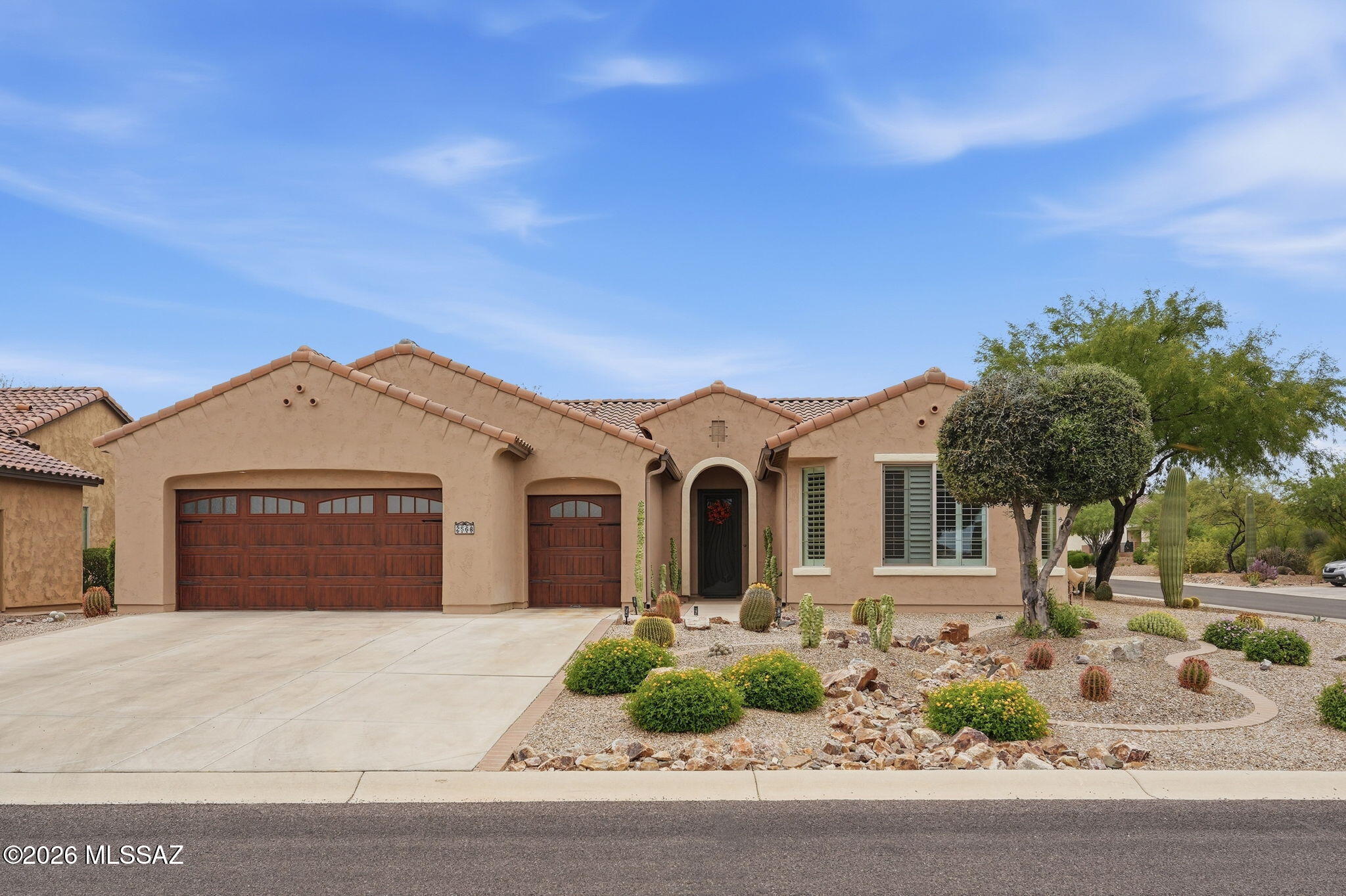 This spacious Cortez model offers 2,111 sq. ft. of living space featuring polished tile floors, high ceilings, and plantation shutters throughout. The kitchen comes equipped with high end appliances, while the master suite includes a walk-in shower, a walk-in closet, dual sinks and upgraded countertops. The secondary bedroom has its own private bathroom and a generous closet; both bedrooms are enlarged with bump outs, adding extra square footage. The home boasts a split floor plan, a well-sized office, and a third guest half bath. The private backyard is beautify landscaped and has a fully enclosed patio/Arizona room, which is complemented by an additional outdoor patio and a mini putting green. The extended garage accommodates large trucks, and also has a separate golf cart garage.