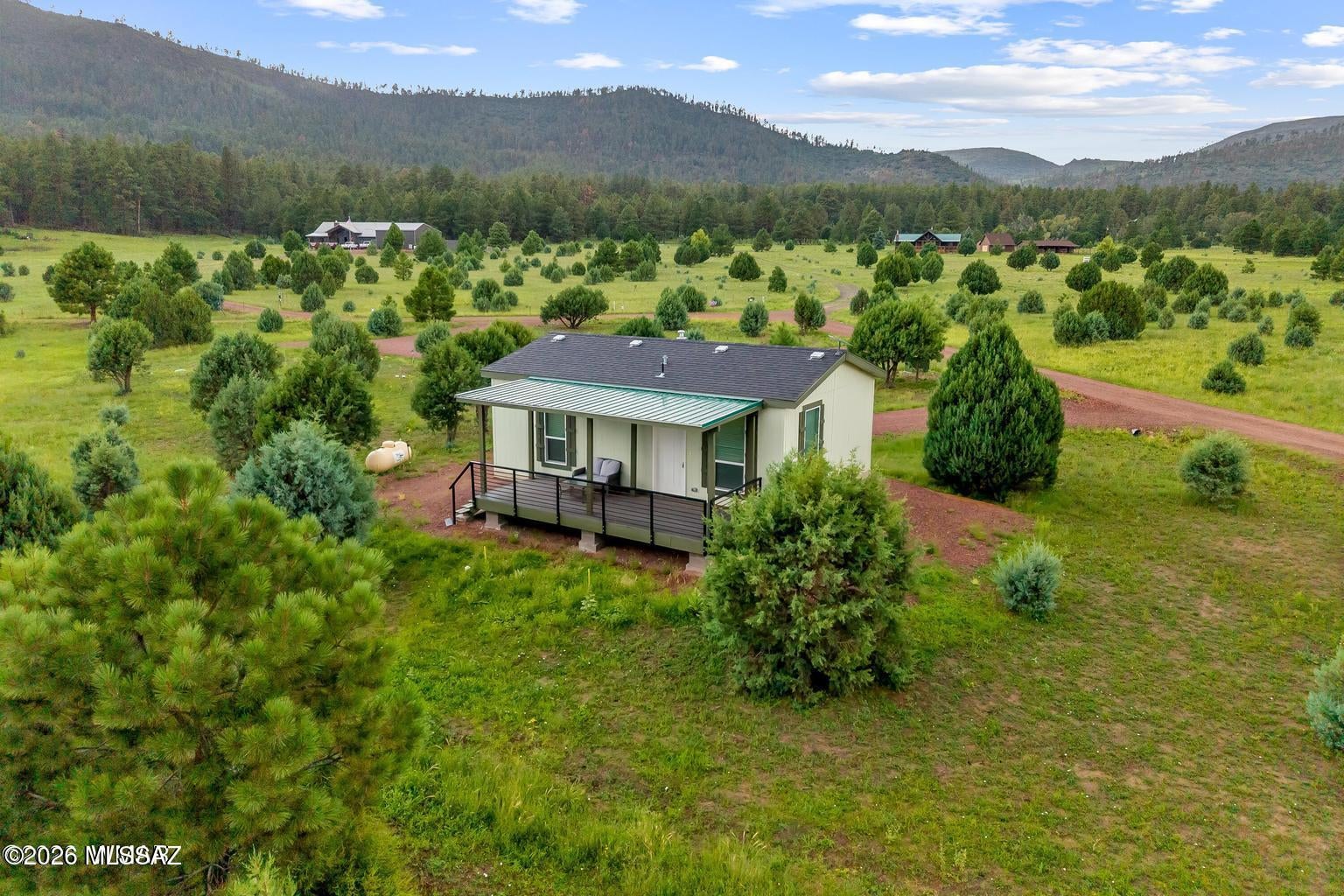 Gorgeous, TURN-KEY, fully furnished, manufactured home on 3.59 acres with PANORAMIC VIEWS AND NO HOA--AT THE FOOTHILLS OF GOBBLER PEAK!! ALL Infrastructures in place, including a private well, septic system, power, and separate circular driveway for RV WITH HOOK-UPS, WOW!! Perfect for a seasonal getaway or Investment property. Cavco West 20x30 Manufactured Home. Escape to the peaceful White Mountains with this beautiful, turnkey manufactured home situated on 3.59 acres with no HOA. Nestled at the base of Gobbler's Peak and tucked away in a private canyon in Nutrioso, this fully furnished 2-bedroom, 1-bath home offers approximately 600 square feet of thoughtfully designed living space The stylish kitchen features a gas range and modern finishes, while luxury vinyl tile flooring, carpeted bedrooms, forced-air heating, and a walk-in shower with bench provide comfort and convenience. Stackable washer and dryer hookups are also in place. Enjoy spectacular canyon views and abundant wildlife from the covered front deck--perfect for relaxing with your morning coffee. The property includes a private well, septic system, circular driveway, and an additional RV space with power and access to the septic system. Surrounded by outstanding hunting, fishing, hiking, biking, lakes, rivers, and streams, this secluded mountain retreat is ideal for the outdoor enthusiast or anyone looking to escape the heat. Move-in ready and waiting for you