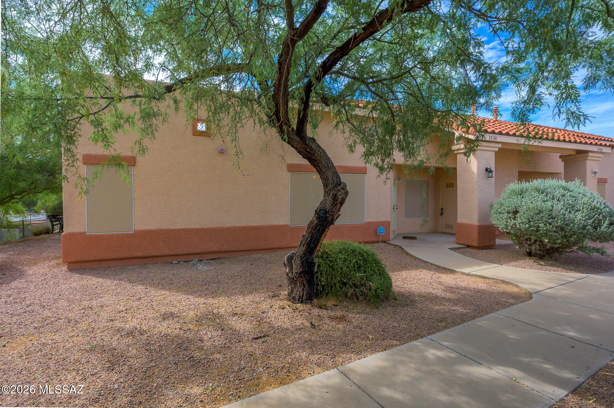 Well-maintained, non-age restricted townhome near shopping center with easy access to Interstate 19. Yet in a small quiet neighborhood where residents enjoy a community pool, landscaping and exterior maintenance by the HOA. This sparkling clean two bedroom features tile flooring and ceiling fans throughout, all appliances and window treatments, split bedrooms, both with large walk-in closets. The spacious kitchen overlooks a private, covered patio. Reserved covered parking and additional spaces are located directly in front of this townhome, set back from the main street.