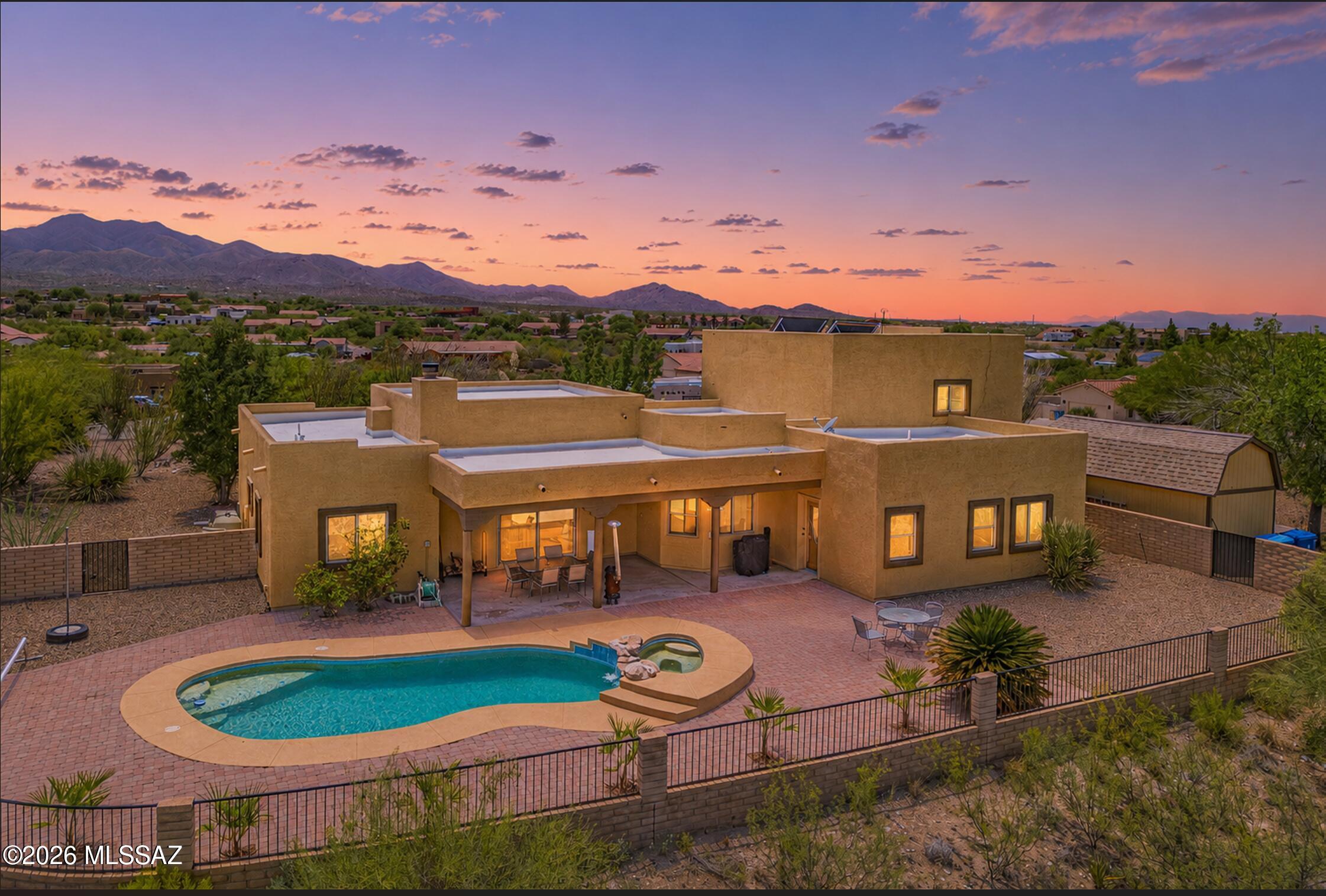 Lovely 5 bedroom, 4 bathroom home with pool, hot tub, stunning mountain views in every direction, on elevated oversized almost 1-acre lot with no neighbors behind!  Desirable Vail School District neighborhood with paved roads and NO HOA!  Downstairs provides spacious living area with wood-burning fireplace and high ceilings, open kitchen with stainless steel appliances and tons of cabinet and countertop space, formal dining room, large primary suite with huge closet, double sink vanity, separate shower and jetted tub in bathroom, PLUS two additional bedrooms, full bathroom, and powder room.  Upstairs you have a gigantic balcony connecting two oversized bedrooms, providing stunning views of the foothills of the Santa Rita Mountains, plus full (recently remodeled) bathroom. North-facing backyard is an entertainer's dream, with privacy and freedom as you enjoy your extended covered patio, relax in your pool and hot tub (with newer pool pump and LED light), and gaze out to the Rincon Mountains beyond. Front of home provides large driveway with a ton of extra parking, giant TUFF shed for extra storage, and low-care, well manicured landscaping.  Insulated THEATER ROOM off of 2 car attached garage with all equipment, screen, and mini split, could also be converted into home gym, studio, office, or game room!  ALL APPLIANCES STAY, including washer and dryer in laundry area with utility sink and extra cabinets.  Roof recoated 2024!  Entire interior just repainted!  All new ceiling fans and light fixtures in bedrooms and bathrooms!  All new carpet downstairs! Newer HVAC units, both from 2021!  All window coverings stay!  High, elevated lot to enjoy daily sunrises and sunsets!  Views from every window in the home!  Top-rated Vail School District!  Beautiful property, perfect for families, multigenerational living, work-from-home set up, and resort-like lifestyle.  Welcome to the next chapter!