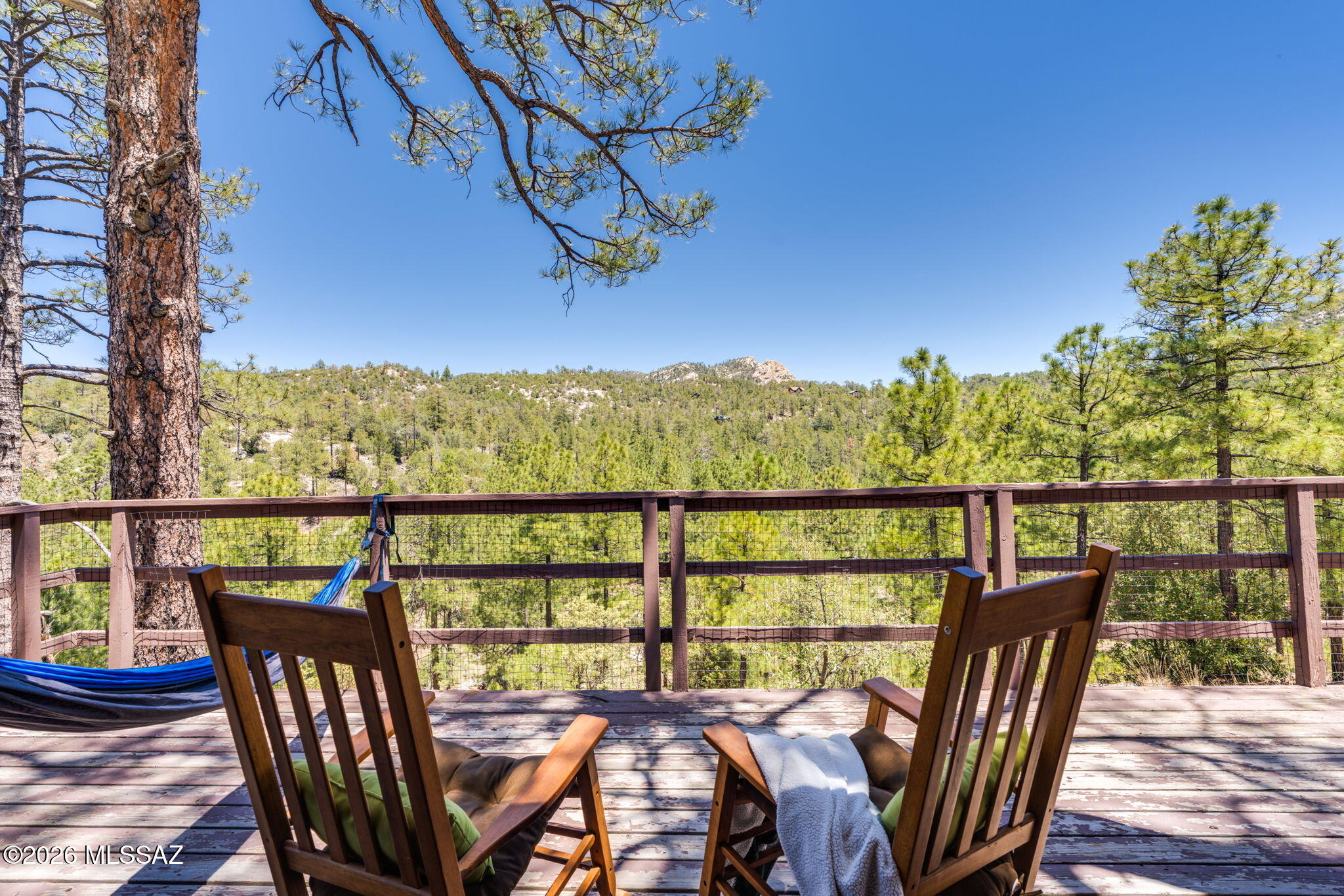 Escape to the cool mountain air of Willow Canyon on Mount Lemmon, where this charming rustic cabin offers a true back-to-nature retreat at approximately 7,000 feet in elevation. Tucked among towering Ponderosa pines and oak woodland forest, this peaceful getaway provides a refreshing summer respite from the Tucson valley heat, with temperatures often 15-20 degrees cooler during the summer months. Positioned on a desirable north-south exposure, the cabin is filled with an abundance of natural light, creating a warm and inviting atmosphere throughout. The north-facing deck offers the perfect setting to relax any time of day while enjoying the serenity, privacy, and natural beauty that surround the property. Inside, the cabin features approximately 486 square feet of thoughtfully designed living space with high ceilings that enhance the open and airy feel. The kitchen is appointed with granite countertops, while the cozy fireplace creates the ideal ambiance for gathering with family and friends on cool mountain evenings. A full bathroom with a compost toilet provides modern convenience, and an additional outhouse offers added flexibility and functionality. Whether you are seeking a peaceful seasonal retreat, a weekend escape, or a place to reconnect with nature, this Willow Canyon cabin captures the essence of mountain living in one of Mount Lemmon's most tranquil settings.