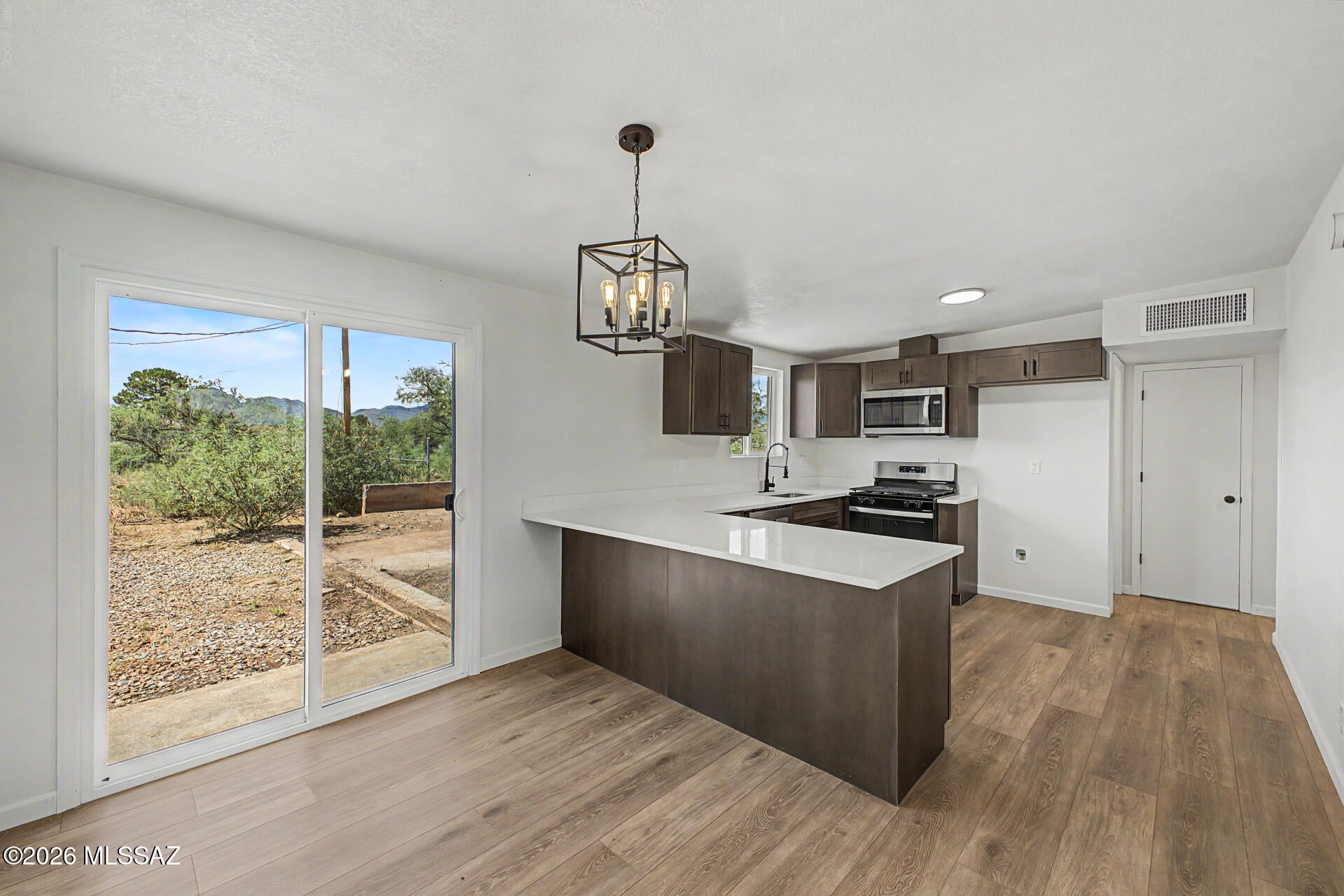 Enjoy space, privacy, and comfortable living in this updated 3-bedroom, 2-bath home in Whetstone Mesa Estates. Situated on an expansive 1-acre lot, this property offers plenty of room to create your ideal outdoor retreat, bring your toys, enjoy hobbies, or simply relax and take in the open surroundings. Inside, you'll find luxury wood-look plank flooring, plush bedroom carpet, modern lighting and plumbing fixtures, rich brown cabinetry, new countertops, chic tile shower surrounds, stainless steel appliances, and fresh interior and exterior paint. A great opportunity to enjoy an updated home with the freedom and space of an acre lot. A must see!