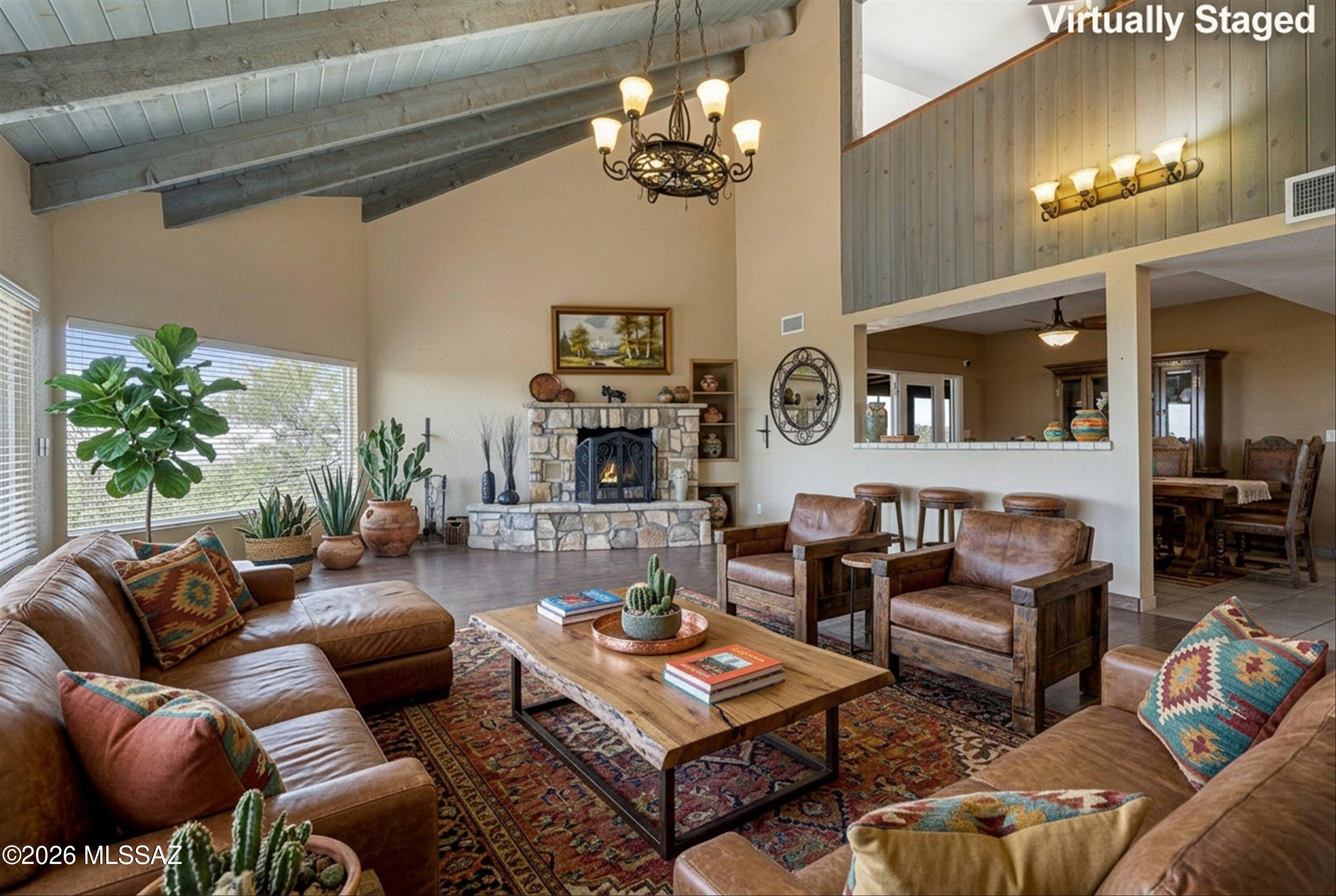 This TAR HOME TOUR Winner rests at 3623 ft elev on 4.83 acres in the foothills of the Santa Rita Mountains. Bring your horses & ride the trails directly onto the bordering BLM land. There's amazing space for entertaining, inside the enclosed patio or on the expansive outdoor patio, plus artificial turf area, a Built-in BBQ and a regulation sized sand volleyball court.  Enjoy the panoramic views from inside all 3 bdrms, the Loft and Living Room which has a Vaulted Ceiling, Wood Burning Fireplace & Rolling shutters on both picture windows. Corian Counters, slide-out shelves and walk-in pantry are just a few of the many kitchen amenities. Full RV Hook-up w/ 50amp elect, plus car charging outlet. The 3 car gar has an evap cooler plus add'l storage. Owned Solar, Gated Entry & NO HOA!