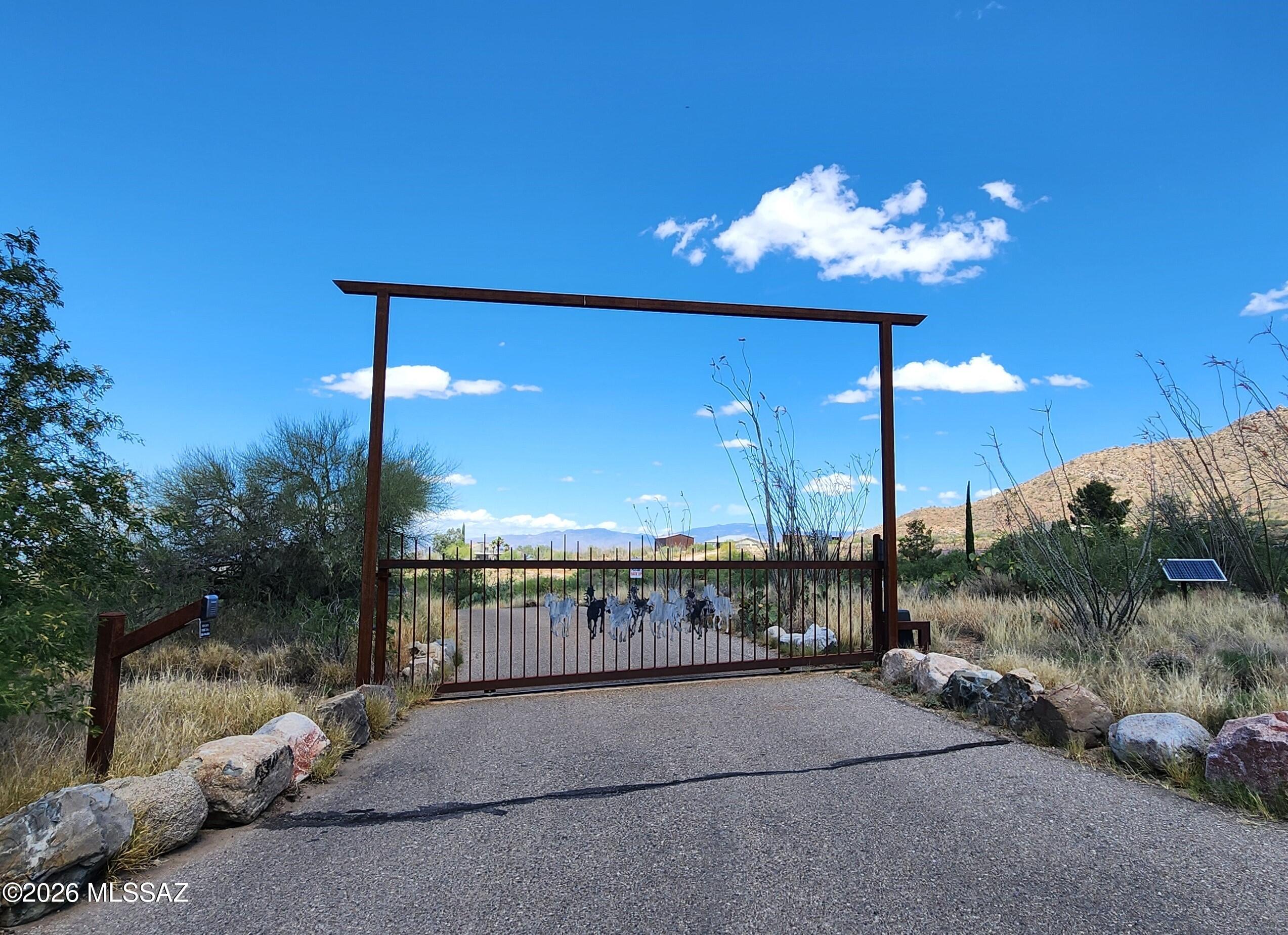 Bring your horses and ride the trails through the state land, which borders the Northern boundary. When you're finished, take a plunge in the soothing swim spa, then sit back and relax on the large patio while sipping a glass of wine, watching the sunset over the mountains. This SW home rests within a small gated community & NO HOA. Spacious rooms and great outdoor spaces to enjoy with family and guests alike. Enjoy a game of Volleyball/Badminton on the regulation size court. Host a BBQ while taking in the fabulous scenery that surrounds this beautiful home. So many extra features; Great Mountain Views from inside and outside, Owner Solar, Horse Facilities w/Shade and Water supply, Full RV Hook-ups, Swim Spa, Huge Screened in Porch and SO MUCH MORE! *See Amenities List*