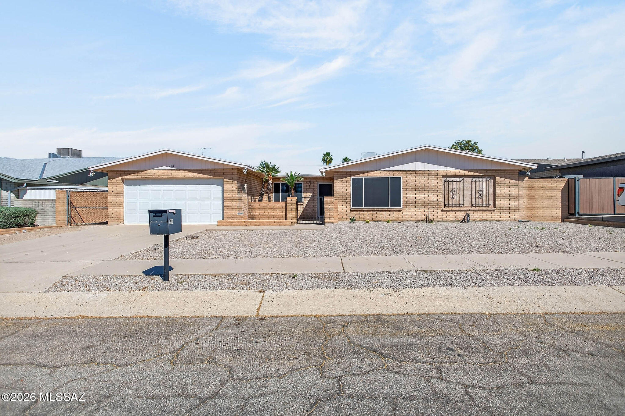 2,227 sq. ft. home with 4 bedrooms and 2 baths on an oversized lot just under 8,000 sq. ft. Mountain views, block wall, and separate gated area for play yard, dog run, or other uses. Front gated courtyard.  NO HOA> 
New flooring throughout. Kitchen updated with white cabinetry, new hardware, quartz countertops, new sink with spray faucet, built-in microwave, range, Bosch dishwasher, and stainless steel French door refrigerator. Kitchen opens to an oversized family room with two linen closets and French doors to the backyard.
Flexible floor plan with a primary suite and attached flex room separated by a barn door, plus additional access to the main living area. Primary suite includes French doors to the side yard and a private bath. Bathrooms updated with newer vanities, mirrors, lighting quartz countertops and undermount sinks.  Newer HVAC system, Roof replaced in 2025. 
The living room has wood-burning fireplace.  You will enjoy the large laundry room. 
Two car garage with a workshop and plenty of storage room and shelving. The long concrete driveway has plenty of room for many guests.  This home has been owned by one family for over 40 years. You will love to make this your home.