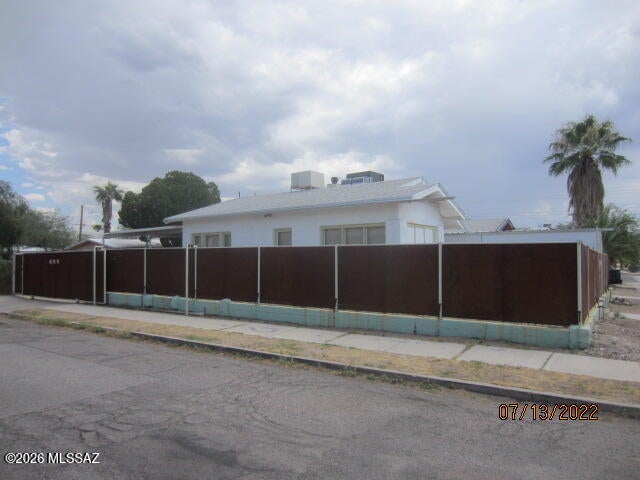 Charming & affordable 1918 Bungalow with separate studio apartment located just minutes away from the   University of Arizona, Pima College West Campus, downtown, & 4th Ave. The main home has 2 bedrooms, 1 bath, & a den. Some special features of the main home include oak floors, updated kitchen with granite counter tops & stainless steel appliances, updated bath with tub, and central air-conditioning. The cozy guest apartment has a small bath & kitchenette. Other features of this home  include an oversize 2+ car carport that doubles as a patio, a separate storage building, C-1 commercial zoning, and the lot is completely fenced.