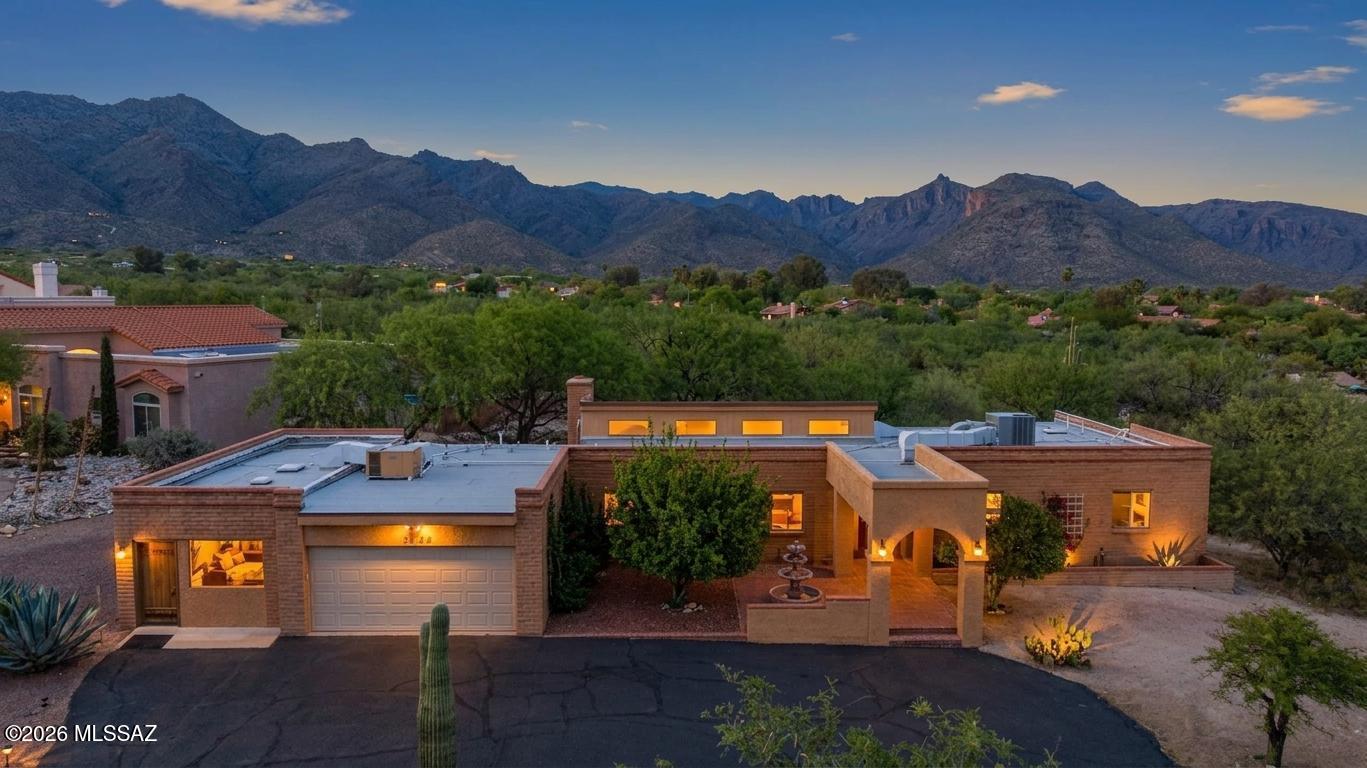 🌵 Desert Charm Meets Modern Comfort in North Tucson 🌄 Welcome to your own slice of private Sonoran paradise! Nestled in a quiet pocket of the Catalina Foothills, this beautifully maintained 2,773 SqFt 4 bed/2.5 bath, split floor plan, attached 386 SqFt 2 car garage, featuring attached 698 SqFt guest quarters/second primary bedroom with separate entrance. Perfect solution for those seeking a multigenerational living solution, an Airbnb investment property, live in one/work out of the other, seasonal visitors and investors alike.
This unique property blends the timeless character of a classic 1985 southwestern masonry ranch home with the comfort and convenience of modern updates. Located in the vaunted Catalina Foothills School District on unsubdivided 1.13 acre CR1 premium corner lot, no HOA offers the freedom you've been craving, including space to store your RV, cars, trailer, toys or add a pool. 
E/W orientation provides panoramic Catalina mountain views and epic sunsets, single story, no stairs/no steps, circular paved driveway offers ample parking, native plants, raised flower gardens, water fountain and lemon tree. Priced well below the $777,020 RVM property value.
Inside buyers will appreciate Milgard energy efficient double pane windows, exposed masonry walls provide distinct southwestern charm, copper plumbing, zoned HVAC, digital thermostats, painted textured ceilings (no popcorn), skylights, recessed lighting, ceiling fans, southwestern inspired tile w/plush carpet in the bedrooms, internal laundry room with white washer and new dryer (2025) included, formal dining area or use as a den, updated full guest bathroom featuring executive height full slab granite counter vanity, walk-in glass tiled shower w/river rock shower floor, spacious living room with large picture and clerestory windows provide amazing natural light and wood burning plumbed for gas masonry fireplace, adjacent to kitchen with peninsula bar seating, wood kitchen cabinets and drawers, stainless steel appliance package including side by side refrigerator w/ice/water dispenser, gas stove and dishwasher (both new in 2025).
Retreat to the massive primary suite, with amazing natural light, Catalina mountain views and separate slider out to covered extended patio. The remodeled updated ensuite  primary bathroom features full slab granite modern executive height vanity, walk-in tiled glass shower with matching river rock shower floor, extra large separate tiled soaking tub and walk-in closet. 
Sip your morning coffee or enjoy tranquil sunsets from under extended covered back patio with stunning panoramic Catalina mountain views, natural desert landscaping, mature Mesquite trees, septic sewer clean outs, metal gutters and 200 AMP electrical panel.
Fantastic North location walking distance to Sabino Canyon Park, minutes from Loews Ventana Canyon Resort, golf course, restaurants, shopping, and multiple hiking trails/biking trails.
Whether you're entertaining, relaxing, or stargazing under Tucson's famous skies, this move in ready home offers the best of both worlds, classic Old Pueblo charm infused with modern efficiency. Call to make your appointment to view this one of a kind Tucson property today!