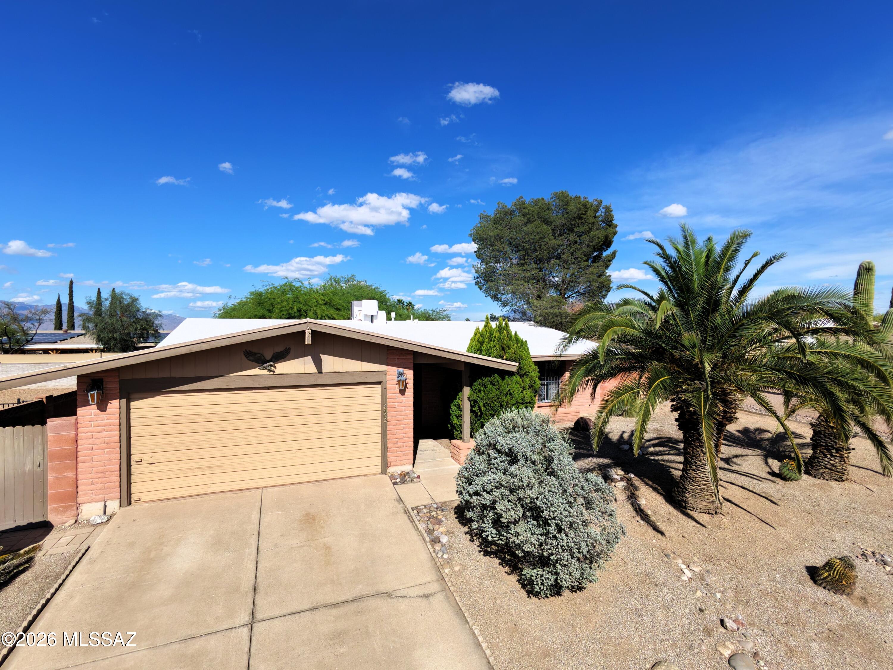 Discover the authentic charm of this long-loved Tucson residence offering a solid foundation and a peaceful atmosphere. Tucked into an established neighborhood, this home stands as a testament to years of consistent ownership and ''good bones.'' The interior is highlighted by tasteful updates, including upgraded flooring and newer bathroom vanities that bring a fresh touch to the home's original character. The spacious backyard serves as a private retreat where you can enjoy the majestic mountain peaks that define the Tucson skyline, creating a beautiful and serene backdrop for quiet desert evenings. While the home retains its vintage soul, it provides a functional, steady canvas for a buyer looking to settle into a well-established property with true potential.