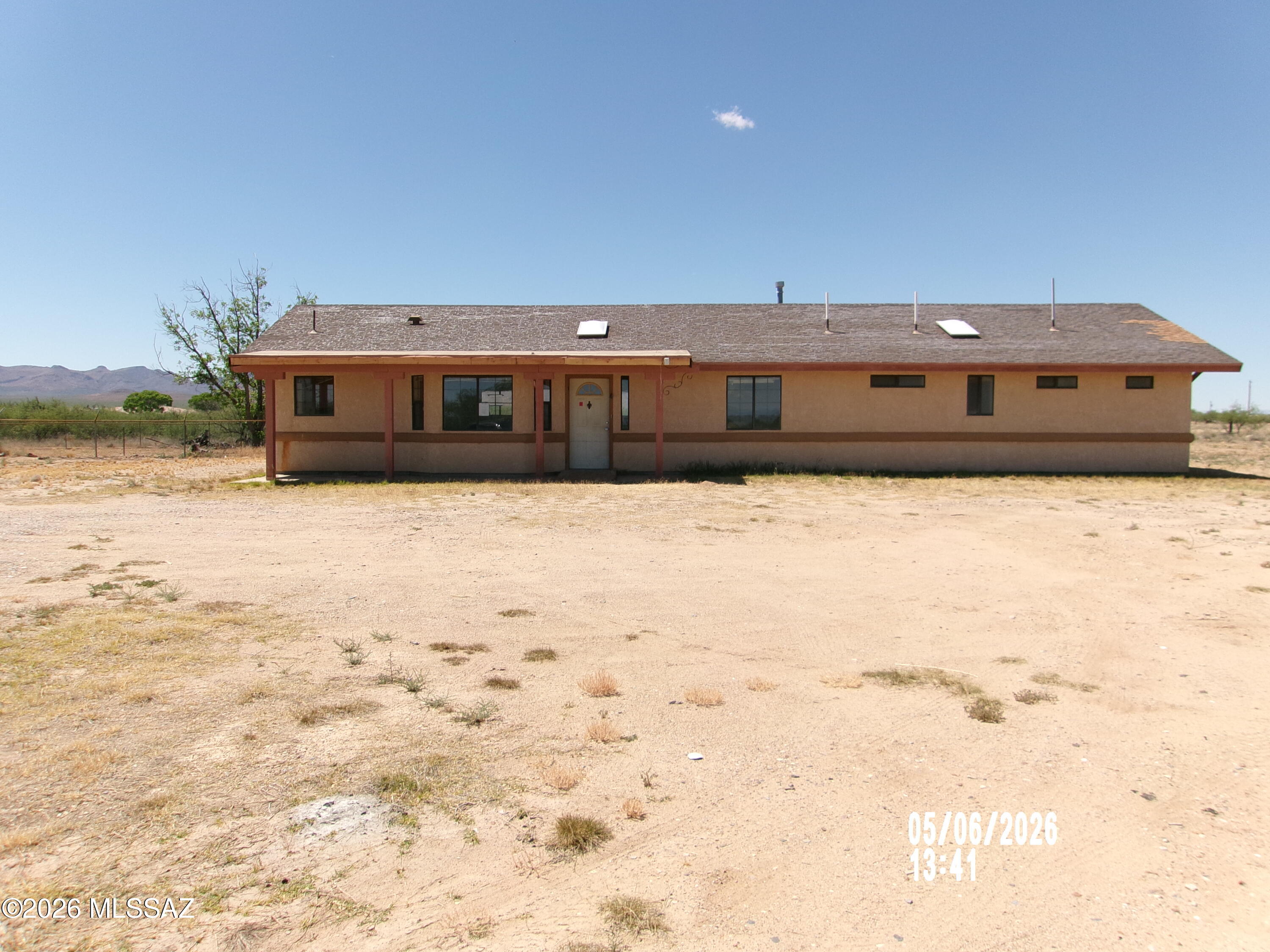 Experience rural living at its finest in this spacious Ranch-style home offering over 2,000 sq. ft. on a scenic 5-acre parcel with panoramic views and breathtaking sunsets. Conveniently located just 15 minutes from town with all paved road access, this property combines peaceful country living with everyday convenience.

Inside, you'll find a huge great room featuring vaulted ceilings, tile flooring, and a cozy fireplace with a raised hearth--perfect for gathering and entertaining. The fully appointed kitchen offers abundant cabinetry, generous counter space, and a sunny dinette area with beautiful window views.

The split floor plan includes three bedrooms, two full bathrooms, and a versatile den ideal for a home office, hobby room, or additional living space. Outdoors, there is ample space for horses, grazing and all outdoor activities.