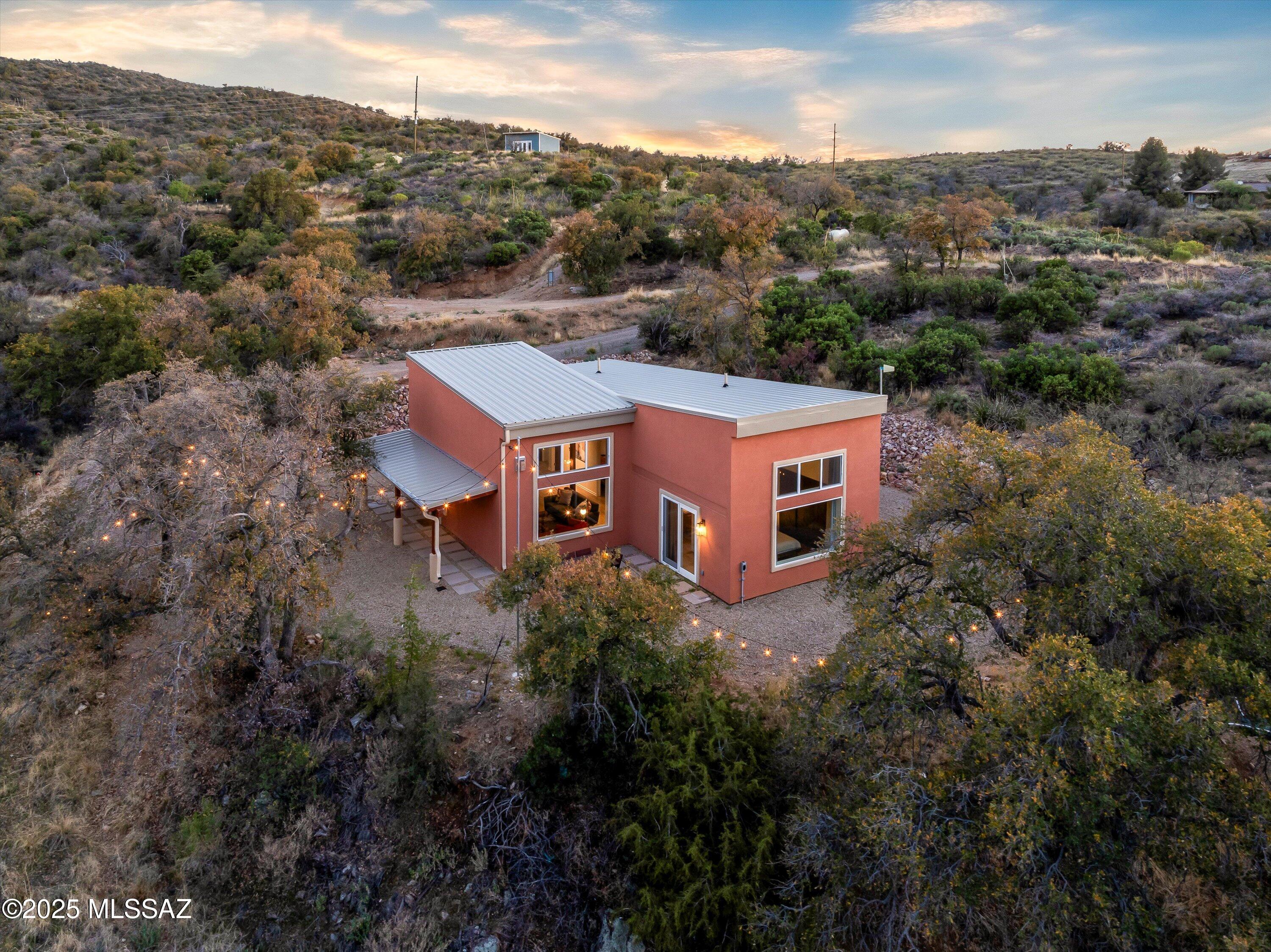 Breathtaking Views, Modern Comforts, and Room to Grow - 6 Acre Retreat in Oracle Endless possibilities and jaw-dropping views await you at this beautifully updated and fully furnished 3-bedroom, 2-bath contemporary home nestled among mature oaks on a private 6-acre paradise. Whether you're seeking peace and privacy or space to expand, this property offers it all—including an additional building pad and a stunning hilltop studio with panoramic 360° views—perfect for sunset watching or stargazing in Oracle's renowned dark sky community. Step inside and experience high-quality craftsmanship throughout, from the pine tongue-and-groove ceilings and quartz kitchen countertops to the center island with induction cooktop, modern gas fireplace, and updated bathrooms. Expansive dual pane windows and vaulted ceilings invite the outdoors in, flooding the home with light creating a bright and welcoming space. Site pad for Amateur Observatory site ready to go. Major upgrades include:New HVAC system,New metal roof & gutters, Upgraded stucco exterior,New bee-hive gas fireplace, Freshly graded & graveled driveway with riprapped hillside, Covered front porch and new paver walkways.
Enjoy all the benefits of Oracle living: 4,500' elevation, cooler temps, no HOA, and endless hiking and biking trails right nearby. With room for horses, guests, an observatory, or your own private retreat, this is the ultimate combination of comfort, beauty, and freedom.This is more than a homeit is a lifestyle. Come see it today.