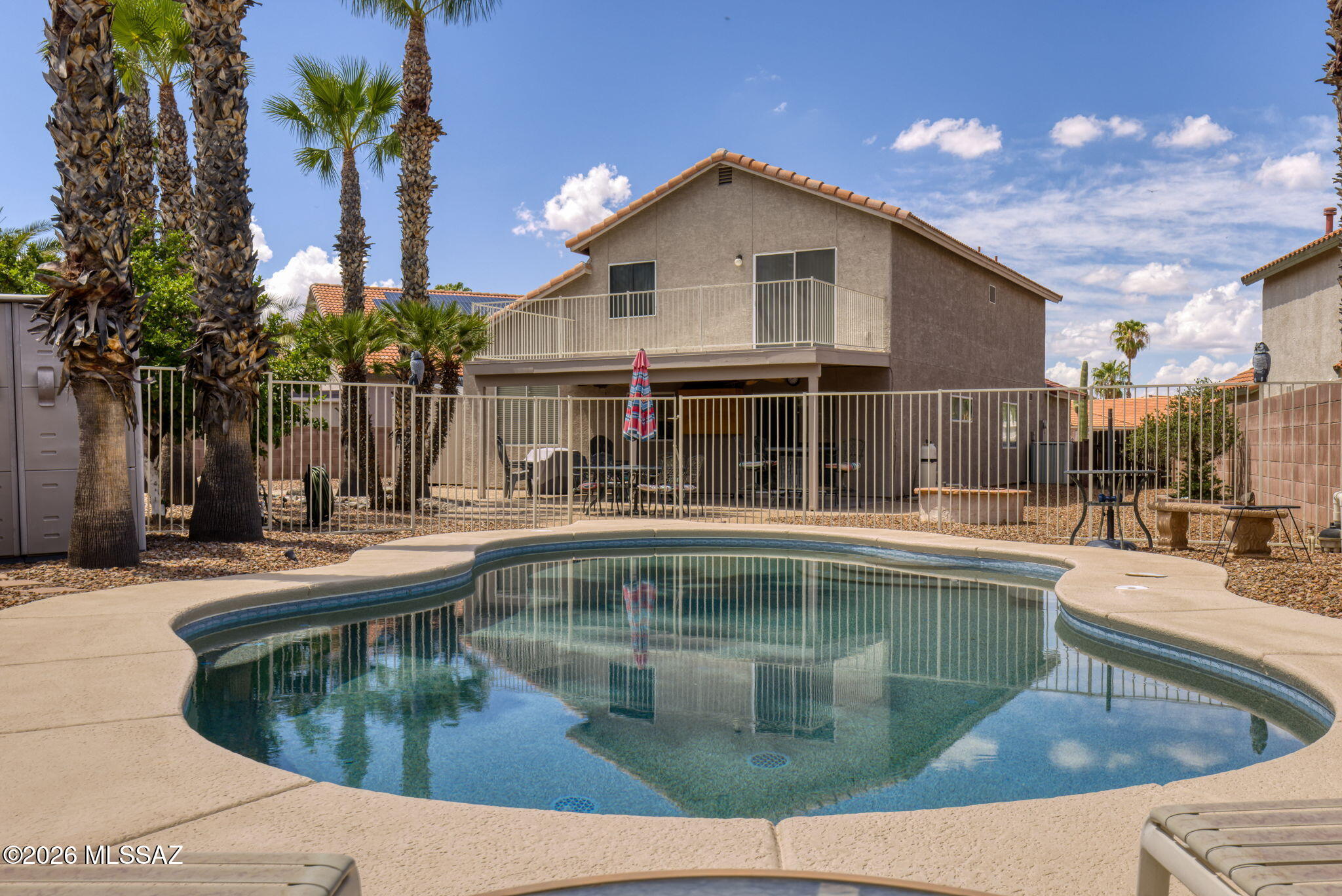 Lovingly cared for and thoughtfully updated, this home reflects true pride of ownership throughout. Exceptionally maintained and move-in ready, the rare floor plan includes a full bedroom and bathroom downstairs, offering flexibility for guests, a home office, or everyday living. And don't forget NEW ROOF Aug 2026!
Outside is one of the home's standout features- a large covered patio overlooking the sparkling Pebble Tec pool, surrounded by mature palm trees that really set the mood for your backyard oasis. There's plenty of space for outdoor dining, entertaining, gardening, or simply relaxing poolside.
Back inside, the open kitchen features rich granite countertops with a matching backsplash, generous prep space, and a view from the kitchen sink that draws your eye straight to the backya Two living spaces give you room to spread out, including one with vaulted ceilings and a cozy gas fireplace for friendly game night or New Year's Eve parties that will be at your house year after year! The second living space feels quaint and comfortable, with natural light and views into the kitchen, breakfast nook, and backyard access. 
Upstairs, the spacious primary suite features a remodeled bathroom, a walk- in closet, and private balcony overlooking the backyard retreat and a mountain view of Sombrero Peak. Two additional bedrooms, another full bathroom and the laundry closet with prep space complete the second floor.
From the meaningful improvements like a new roof in Aug 2026 and no polybutylene pipes to the care throughout, this is a home is ready for its next chapter.