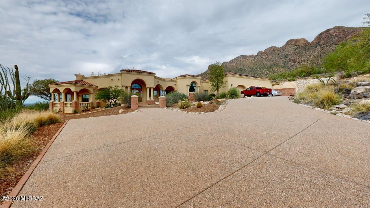 Spectacular foothills retreat on 1.61 acres in Shadow Mountain Estates, offering privacy, panoramic views and exceptional indoor/outdoor living. This distinctive 4,367 sq. ft. residence is surrounded by the natural beauty of the Sonoran Desert, with sweeping mountain, city, desert and sunset views from its elevated setting.

The expansive and versatile floor plan provides exceptional flexibility, with a generous primary suite, second bedroom, two offices, media/flex room (could be 3rd bedroom), family room, formal living room and formal dining room. A dramatic two-sided fireplace connects the living and dining areas, while high ceilings, skylights, an impressive entrance foyer and split-bedroom design enhance the home's open, spacious feel. At the heart of the home, the kitchen features granite countertops, a large island, gas range, refrigerator, dishwasher, reverse osmosis system and breakfast nook, with abundant space for cooking and gathering. The expansive primary bath offers granite countertops, double vanity, jetted and soaking tub, separate shower and bidet.

Outdoor living is where this property truly shines. Extensive covered and open patio areas overlook a heated infinity pool and hot tub, creating a private resort-like setting against the surrounding desert and mountain backdrop. A built-in barbecue provides another inviting space for entertaining while enjoying Tucson's spectacular sunsets.

Additional features include a 3-car garage, workshop, central vacuum, ceiling speakers, zoned central air, natural-gas forced-air heating and solar PV system. The home combines substantial living space with an extraordinary desert setting and no HOA.

A rare Northwest Tucson opportunity offering space, privacy, dramatic views, flexible living areas and resort-style outdoor living -- all on 1.61 acres.