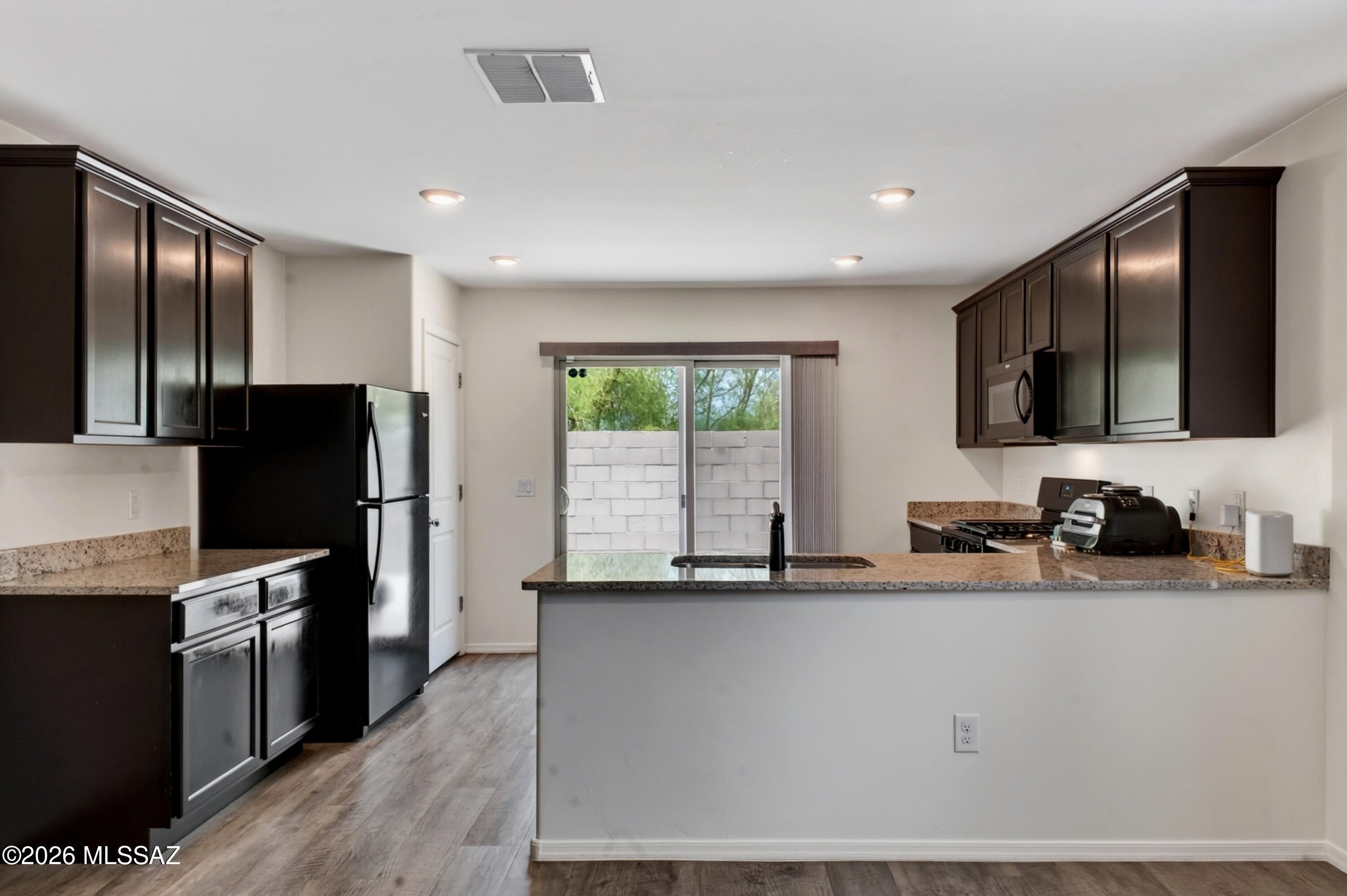 Built in 2019, this 3-bedroom, 2-bathroom, 1,515 sq ft home offers modern, open-concept living with a massive upgrade: a PREMIUM WHOLE-HOME SOLAR SYSTEM. Enjoy true energy independence and drastically reduced utility bills in this move-in-ready South Tucson property. The spacious Great Room flows seamlessly into a bright kitchen featuring striking granite countertops, a gas range, and a deep walk-in pantry. The primary suite provides a relaxing retreat with a large walk-in closet and a private en-suite bath. Complete with central AC, an attached 2-car garage, and a private, block-walled backyard with low-maintenance landscaping, this home is engineered for maximum efficiency and desert comfort. Don't miss this incredible opportunity!