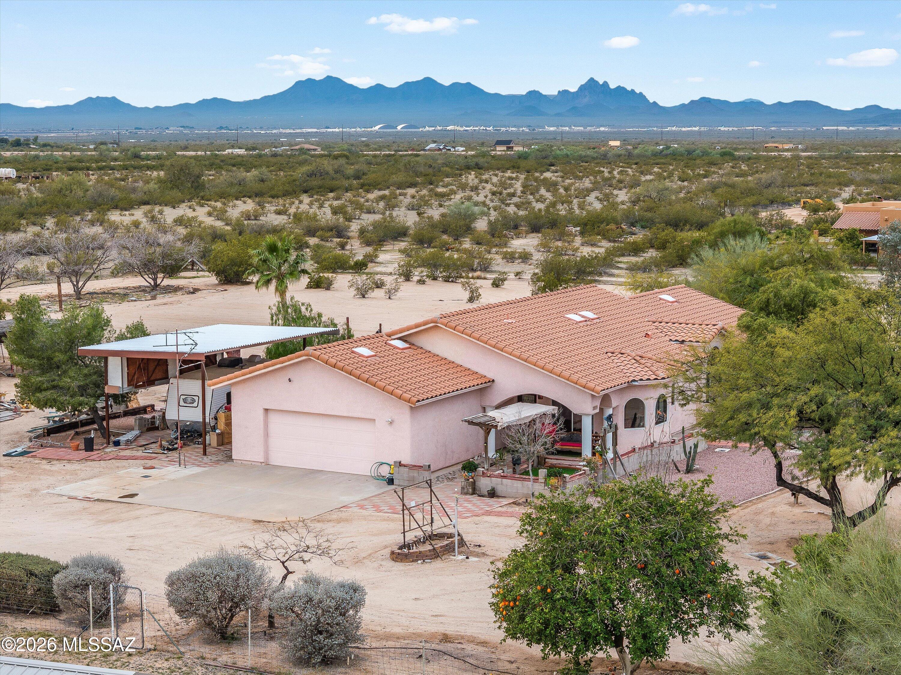 NEW ROOF and NEW WINDOWS.   Experience 4 acres of beautiful high desert in this 3-bedroom home with 2.5 baths, 2 car garage, full RV hook ups, and 3 extra storage buildings. This home is made with metal frame and post-tension flooring.  HVAC, water heater, and appliances are only two years old. High speed internet with Transworld Network. All appliance stay including a chest freezer. Bring the horses and the side by sides, enjoy trail rides for miles.
