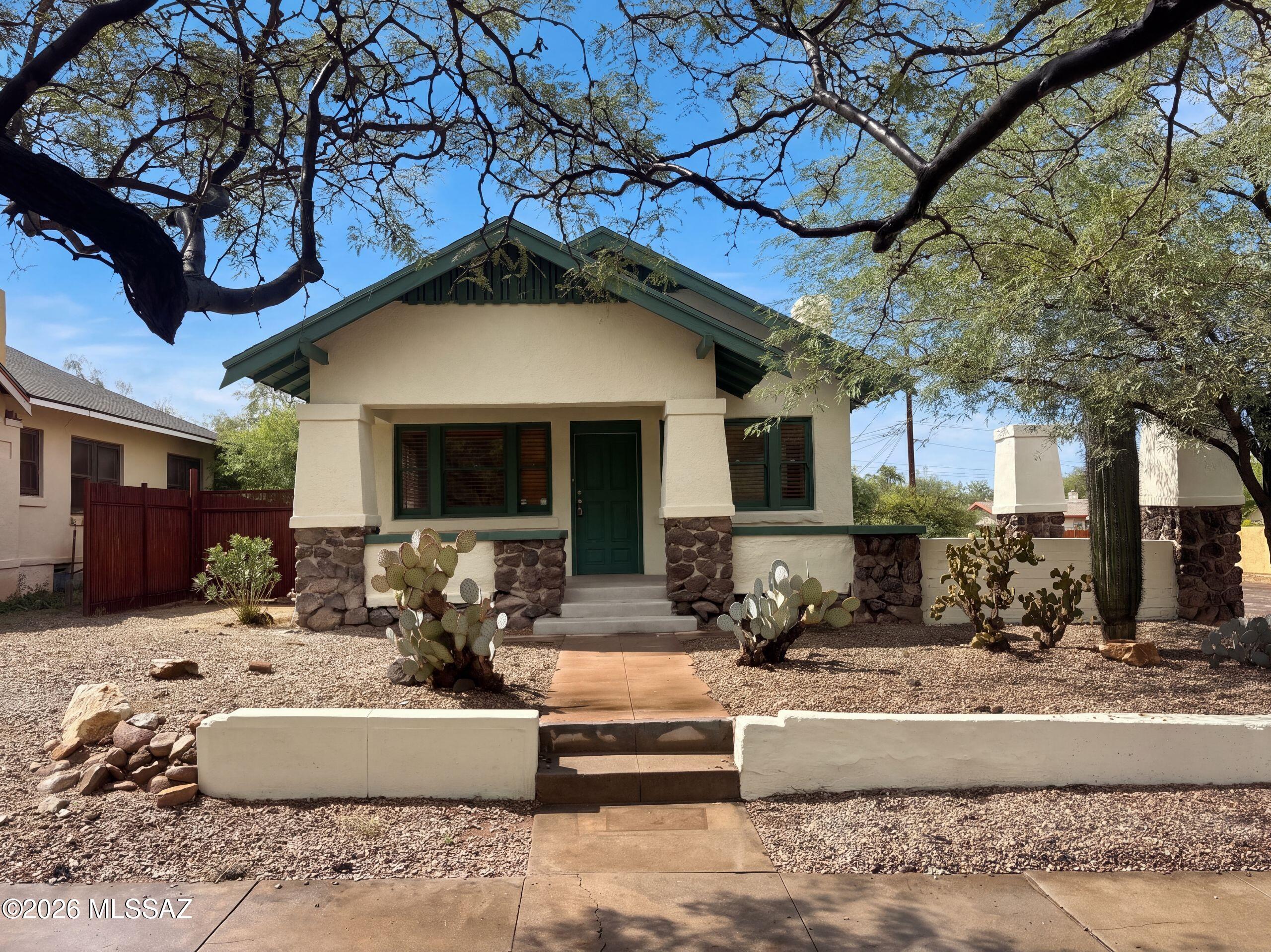 INCREDIBLE BUYER INCENTIVES: $6,000 MORTGAGE CONCESSION. Seller will pay up to $6,000 at closing towards your interest rate buydown if you finance with lender of sellers choice.

1245 N 1st Ave is a single-story Tucson home with a covered front porch and detached casita. The main kitchen includes a peninsula, gas range, refrigerator and dishwasher. A fireplace with shelves on either side anchors the living room. The primary bedroom has open shelving and an in-room washbasin beside an adjoining shower-and-toilet compartment. The main home also has a tub-shower bathroom and unfinished basement space. The casita includes a kitchenette with a cooktop and compact refrigerator, a shower bathroom and a mini-split unit. Outdoor space extends along the rear and side of the main home. Included 100
