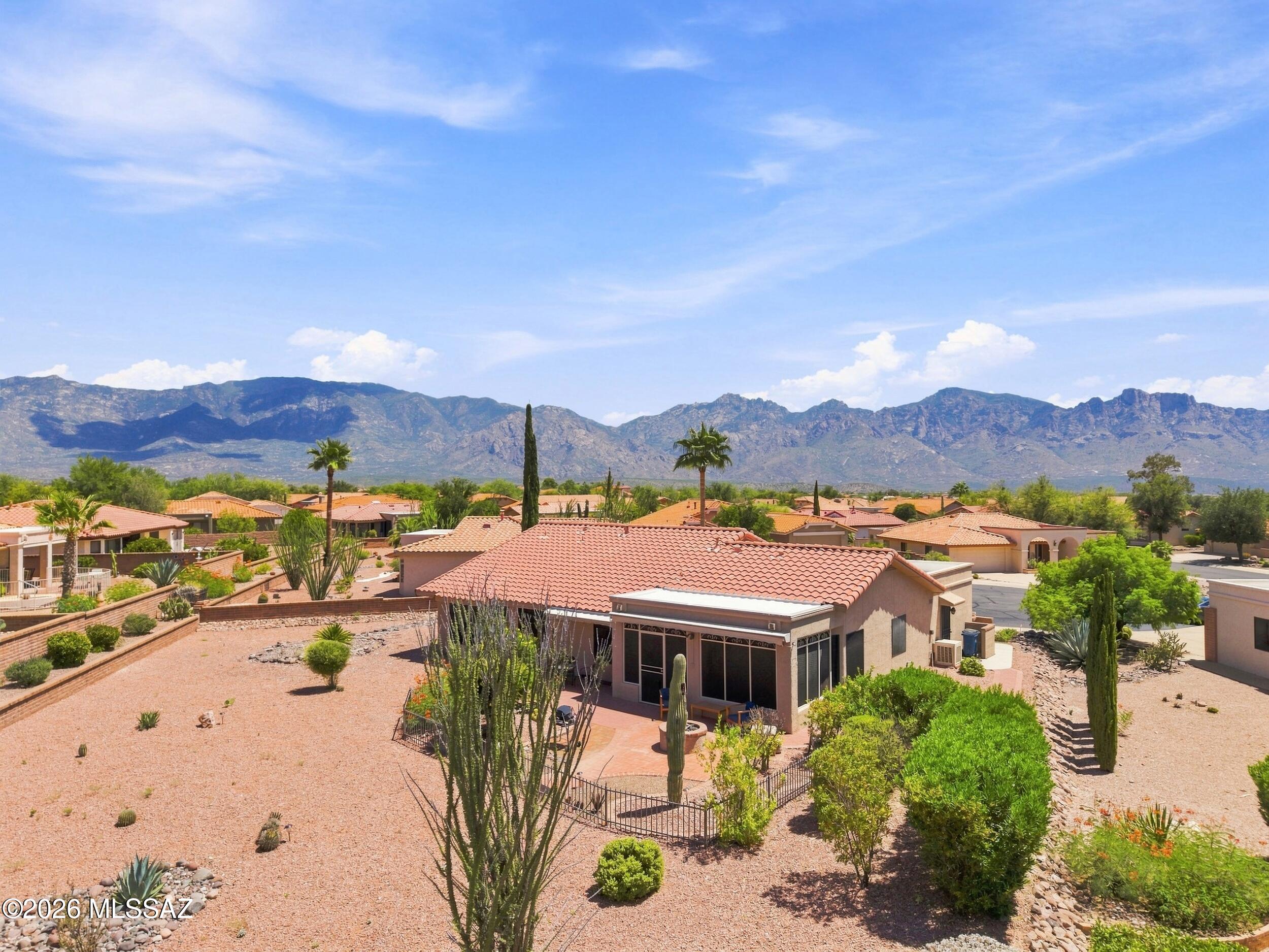 Remodeled within Sun City Vistoso on a .32 AC lot, one of the larger lots in the subdivision. Open-concept living areas, raised ceilings, Mohawk flooring, and a 211 SF addition plus 235 SF 3-season patio. Updated kitchen includes Alder cabinetry, butcher block counters, black stainless appliances, gas range, convection oven, granite sink, and pass-through to the patio. Primary suite offers dual granite vanities, walk-in closet, and walk-in tub with massage jets and therapy lighting. Garage has epoxy flooring, insulation, storage, side entry, and evaporative cooling. Mountain views, covered patios, fenced courtyard, gas fire pit, electronic awnings, mature landscaping, and automatic irrigation. Newer A/C, water heater, & plumbing fixtures. Roof was redone in 2014.