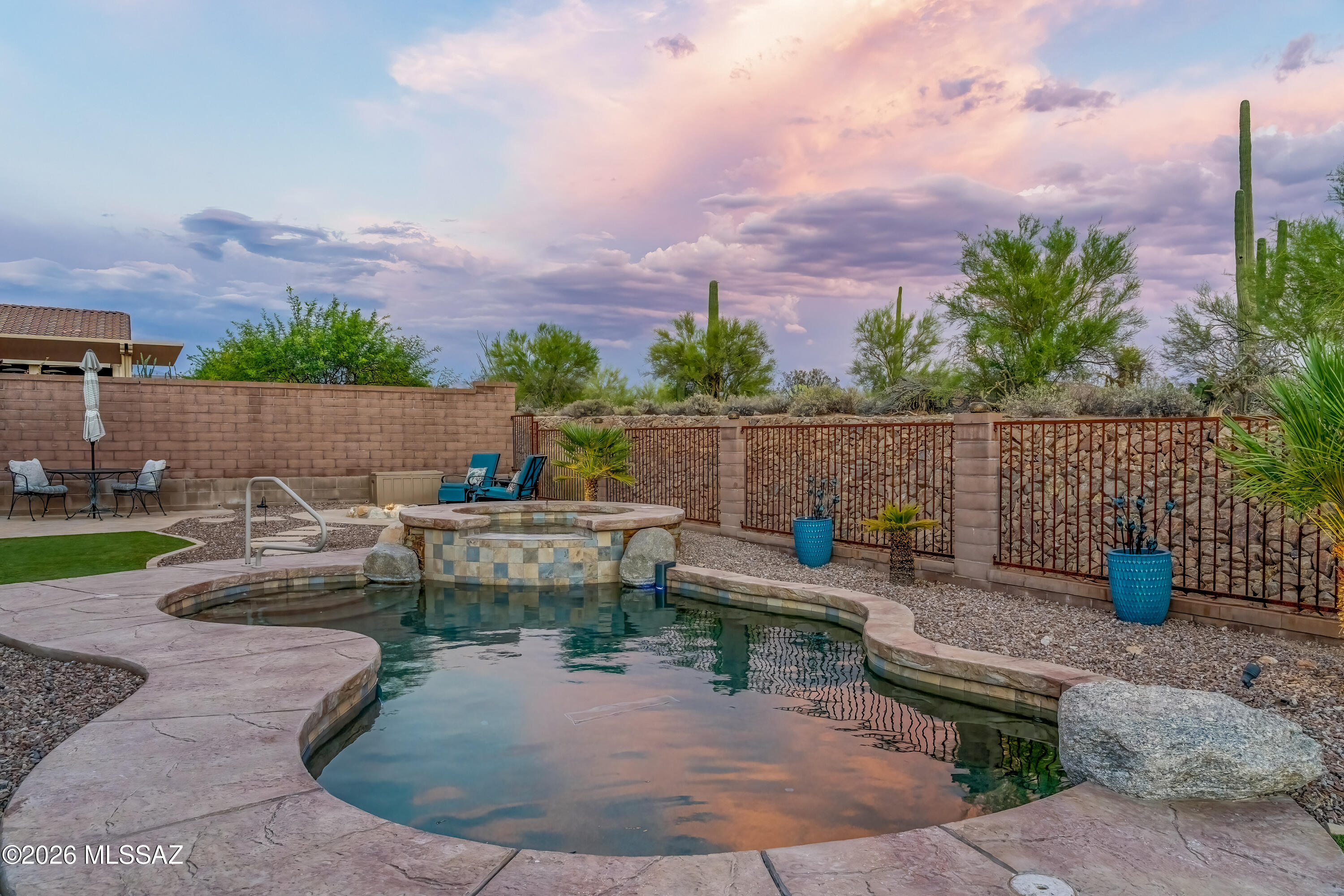 Welcome to Dove Mountain Preserve! This beautifully maintained 3-bedroom, 2-bath home with a den offers an open, split-bedroom floor plan filled with natural light, high ceilings, and tile throughout. The kitchen features maple cabinets, granite countertops, and opens seamlessly to the living area with remote-controlled shades. The versatile den includes its own sliding glass door, making it ideal for a home office, guest suite, or future multigenerational living. Enjoy your private backyard oasis with a saltwater pool, spa, remote-controlled patio shade, Tuff Shed for extra storage, and breathtaking desert views with no rear neighbors. Additional features include fresh interior and exterior paint (2025), a wet bar, laundry room, water softener, and an epoxy-coated garage.