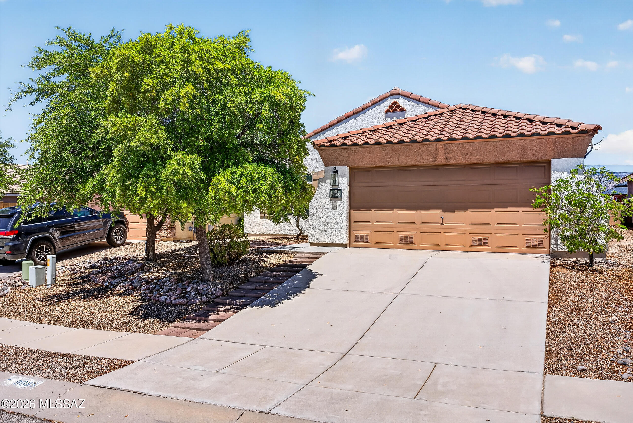 Beautiful East side home in desirable Serenata neighborhood. 3-bedroom split floorplan with two owner's suites, perfect for in-law quarters or even a rental property. Large pool sized back yard with stunning mountain views and fruit tree! Tile in all main living areas with wood laminate in bedrooms. Charming neighborhood with sidewalks.  Move in ready with fresh paint throughout, new kitchen sink and faucet, new hardware on cabinets, new Samsung Bespoke refrigerator, newer gas range, new ceiling fans with lights, some new blinds. Close to shopping and bus stops.