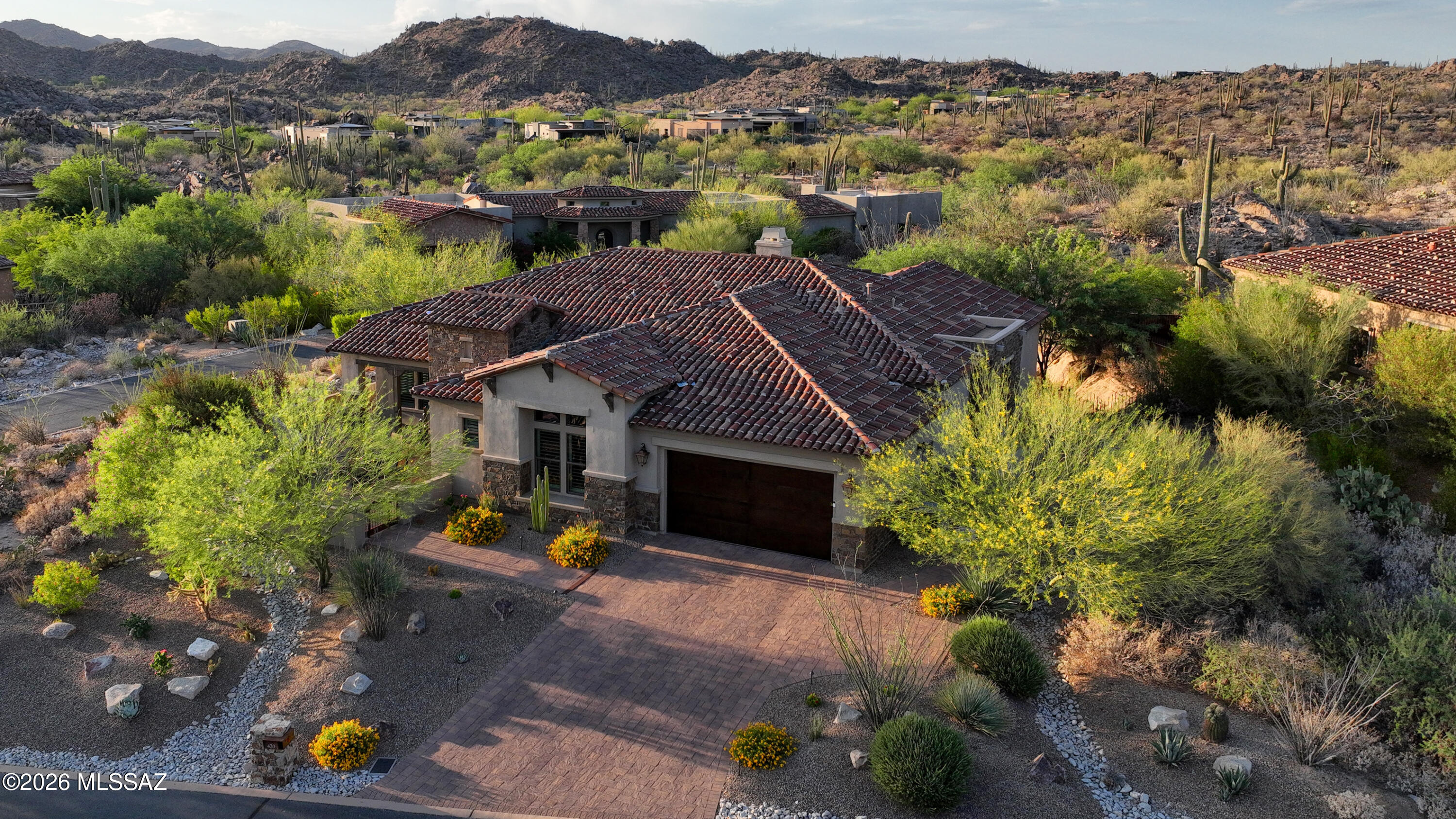 Beautifully updated 3 bedroom + den, 3,078 sq ft home in Stone Canyon's popular Stonegate community. Enjoy the spacious open floor plan with dramatic L-shaped sliding wall of windows to provide true indoor-outdoor AZ lifestyle experience! PRIVATE yard with BBQ & lateral firepit offers seclusion bordered by desert rock outcroppings. Recently remodeled with all new gourmet kitchen featuring large Dekton Island, locally built custom cabinetry, Kitchenaid appliance package, butler's pantry & walk-in pantry. New luxury faux-wood flooring, remodeled fireplace wall, and beams added to great room ceiling. Sumptuous primary suite, 2 guest suites, and separate den. You'll love the bright modern styling and truly immaculate condition of this home. Gated courtyard with Catalina Mountain views!