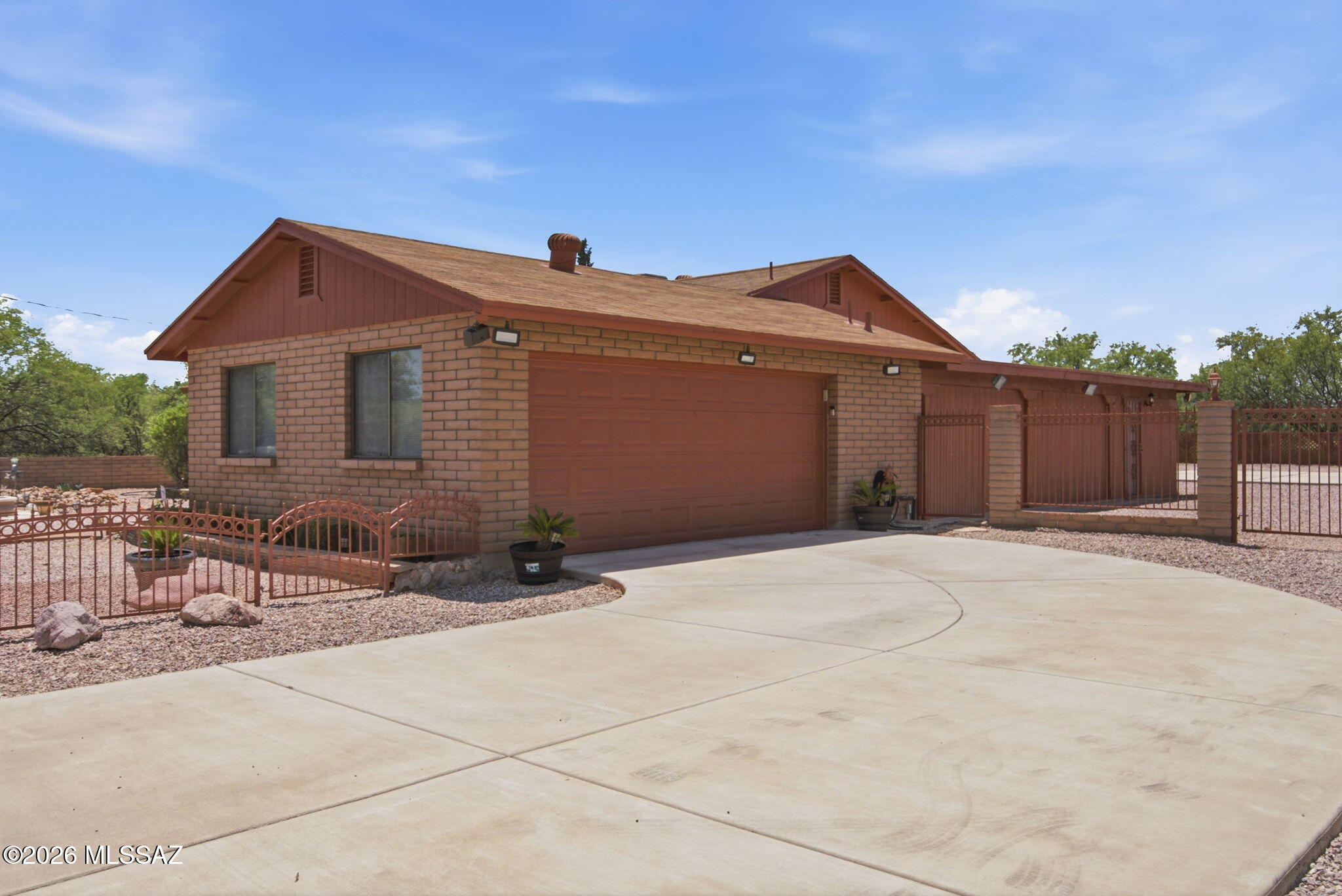 Welcome home to this beautifully maintained property that combines comfort, functionality, and stunning mountain views. Offering 3 spacious bedrooms plus a bonus room that can serve as a TV room, home office, or easily be converted into a 4th bedroom, this home is designed to fit your lifestyle.
From the moment you arrive, you'll appreciate the inviting curb appeal with mature landscaping, and a welcoming front patio with fountain. Inside, the bright and spacious living room features soaring vaulted ceilings and tasteful upgrades throughout.  The open-concept kitchen is perfect for everyday living and entertaining, complete with a stylish tile backsplash, new SS stove and dishwasher, and plenty cabinetry. The desirable split-bedroom floor plan offers added privacy, with the generous primary suite featuring a large ensuite bathroom and an oversized walk-in closet.  Step outside to your own private backyard retreat. Relax under the covered patio while enjoying the peaceful surroundings. The outdoor space also includes three storage/workshop areas, a basketball court, an extended garage, and beautifully landscaped grounds.  Conveniently located just minutes from Interstate 19, this home offers easy access to Nogales, Rio Rico, and Tucson. You'll also be less than five minutes from local restaurants, shopping, schools, and scenic walking trails.  This move-in-ready home offers space, charm, and an exceptional location--an incredible opportunity to make it your own!