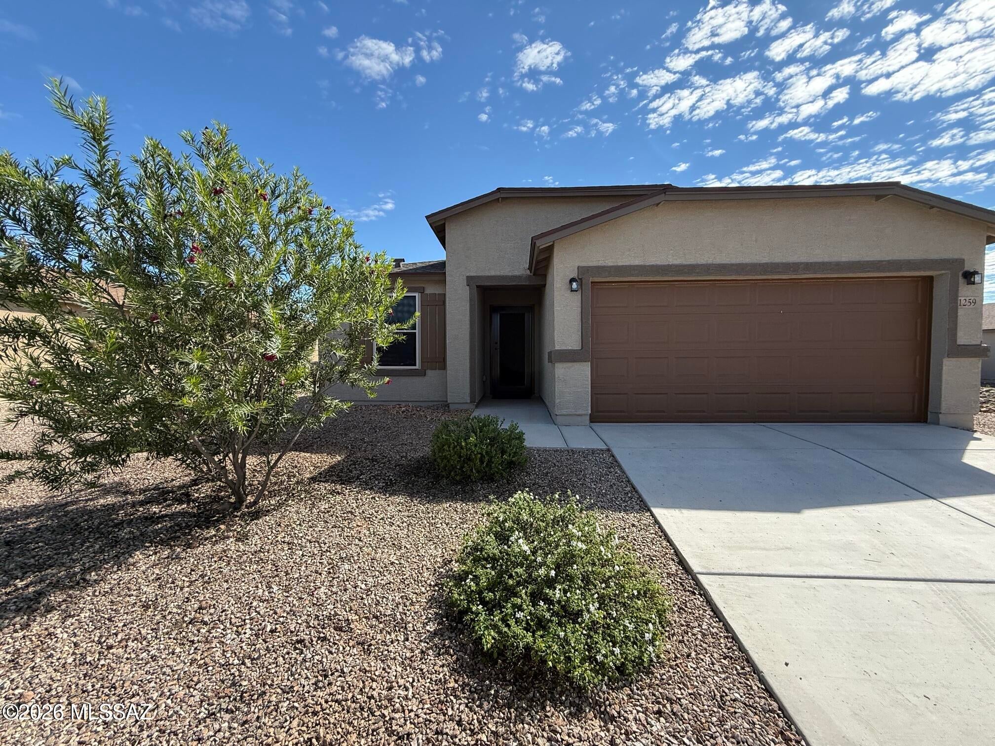 Impeccably maintained 3-bed Benson home with mountain views and an East-facing backyard for cool, shaded afternoons. Interior features durable LVP flooring, Honeywell ceiling fans throughout, room-darkening shades, and dual-pane windows. The kitchen shines with quartz counters, upgraded dishwasher, and matching appliances--with HVAC and water heater all just 2 years old. Both baths boast granite counters; the remodeled primary ensuite has a custom Jacuzzi walk-in shower with tempered glass and dual grab bars. Two bedrooms include walk-in closets. Outside, enjoy an extended paver patio, artificial turf with a 10-year warranty, rock borders, trees, and Rain Bird drip irrigation. Complete with an insulated garage and powder-coated Bulldog security screens, including front entry.