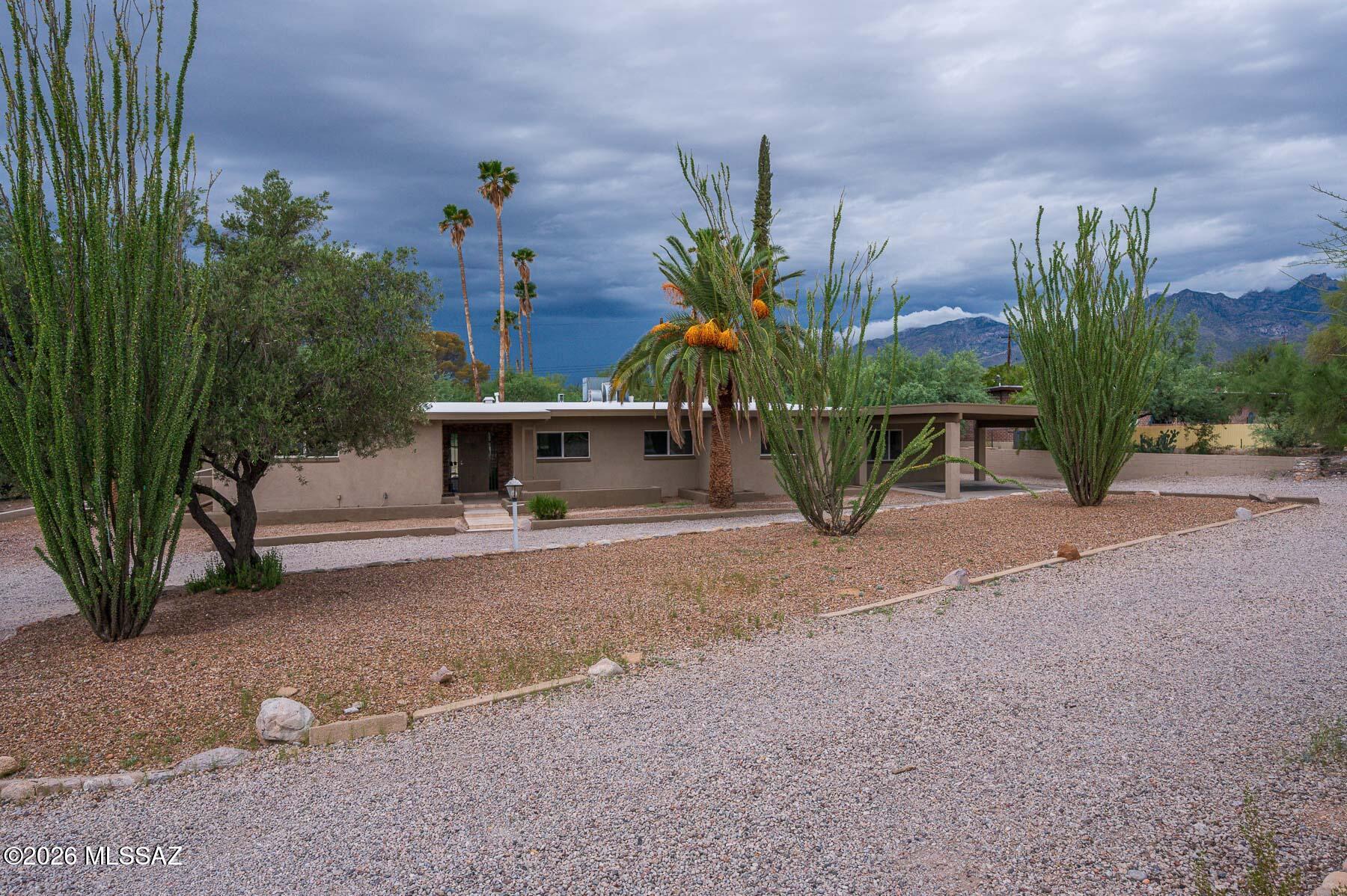 Beautifully updated 5 bdrm, 4 bath home in Bear Canyon Hills. this spacious property offers exceptional flexibility w/dual primary suites, the beautiful updated bathrooms, with a quest quarter. Perfect for extended family & guests. The updated kitchen features quartz countertops & updated cabinetry, creating a modern & inviting space for everyday living & entertaining. Step outside & enjoy your own private pool & inviting outdoor space, all while taking in the beautiful mountain views that make this location so special. A convenient carport provides covered parking, & the home offers plenty of room for entertaining, with dual primary bedrooms perfect for guests or short term rental. Located in the Tanque Verde Valley, close to shopping, restaurants & recreation.