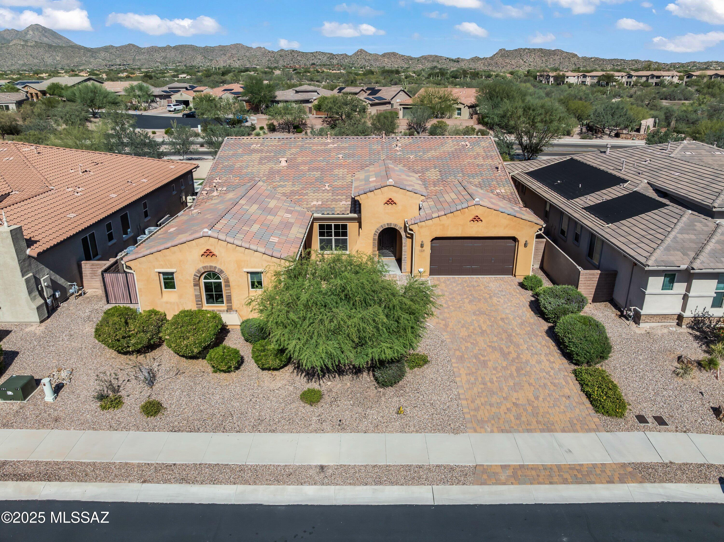 Prepare to be captivated by this stunning 4-Bedroom + Den, 3,800 SqFt residence nestled within the exclusive, gated community of The Pinnacle at Center Pointe Vistoso. The neighborhood offers a lifestyle of unparalleled luxury and convenience against the backdrop of Pusch Ridge in Oro Valley. This home features a dedicated, private multi-generational living suite perfect for guests, in-laws, or a teen. This fully equipped suite boasts a private exterior entrance, a spacious bedroom and bathroom, laundry facilities, a charming eat-in kitchen, and a one-car garage. Residents enjoy access to Center Pointe's community facilities, which include an Olympic-sized pool, a splash pad, built-in grills & fire pits, a clubhouse with a full kitchen for private parties, & multiple playgrounds. See the floor plan and list of house upgrades in the document section.