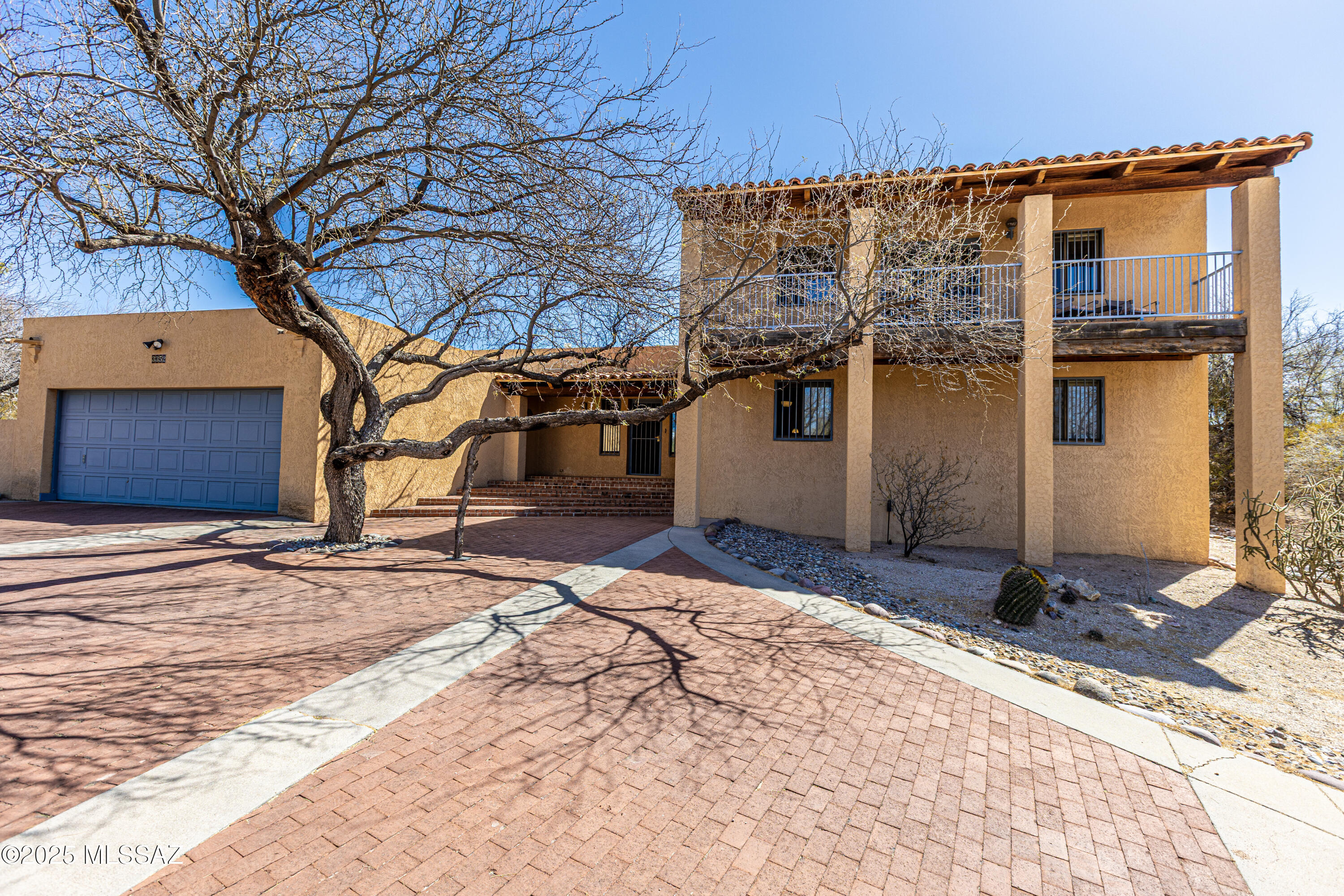 Nestled in the heart of the Catalina Fthls this masonry stucco territoral blends timeless Southwestern charm with mountain views.A dramatic circular driveway with brick inlays & elegant brick steps lead to entrance. The living room features a custom masonry fireplace and french doors that open up to a rock water feature and wrap around patio. The family room boasts a cozy beehive fireplace and rich pecky cedar ceilings. The kitchen is situated between the family room and dining room with raised panel cabinets, mexican tile backsplash The expansive primary bedroom includes sitting area and a balcony with mountain views. Oversized secondary bdrms, one with dual closets. Saltillo flooring. Laundry room complete with sink. Additional highlights include two car garage with workshop/hobby area. Roof work completed with two coats roof coating and underlayment replaced in Tiled areas.