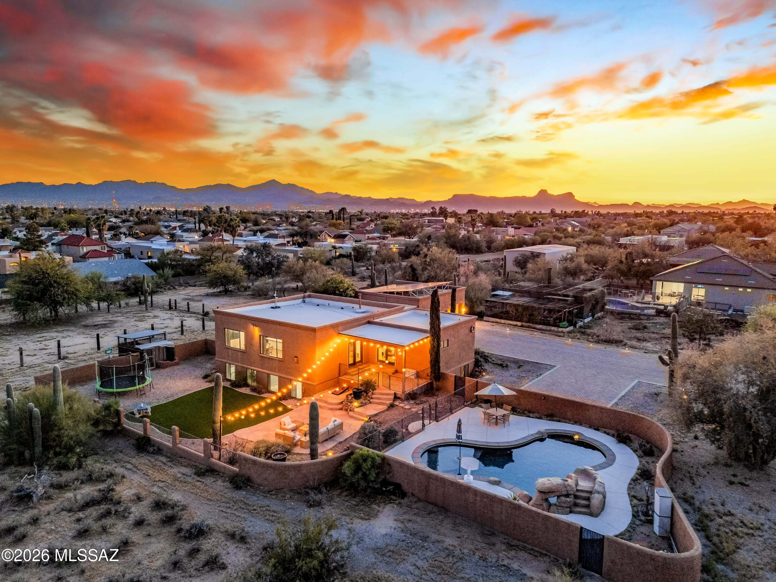 CUSTOM ESTATE | 1 ACRE | NO HOA | VIEWS | DETACHED 3-CAR GARAGE Experience elevated desert living in this custom-built 6-bedroom, 4-bath estate set on an acre, showcasing breathtaking mountain and sunset views. Designed with both presence and livability in mind, this home offers expansive interiors paired with thoughtfully curated finishes throughout. Enter through a private gated courtyard into a light-filled great room featuring travertine flooring, exposed ceiling beams, and a striking stacked-stone fireplace creating a warm yet refined focal point. The chef's kitchen blends style and function with quartz countertops, stainless steel appliances, gas range, custom cabinetry, designer backsplash, and a spacious breakfast bar perfectly suited for both everyday living and effortless entertainment.
The primary suite serves as a private retreat, complete with direct outdoor access and a spa-inspired ensuite featuring dual vanities and a glass-enclosed shower.

A versatile lower level expands the home's flexibility, offering an additional living area, office nook, three bedrooms, and two bathrooms. Ideal for multi-generational living, guests, or work-from-home needs.

Step outside to a resort-style backyard oasis, where a pool with slide, open entertaining areas, and expansive grounds invite you to create your ideal Arizona lifestyle.

Additional highlights include a detached oversized 3-car garage with extended paver driveway, horse property with corral, and the freedom of NO HOA living.

A rare opportunity to own a private, view-filled custom estate offering space, flexibility, and true desert luxury. Owner/Agent