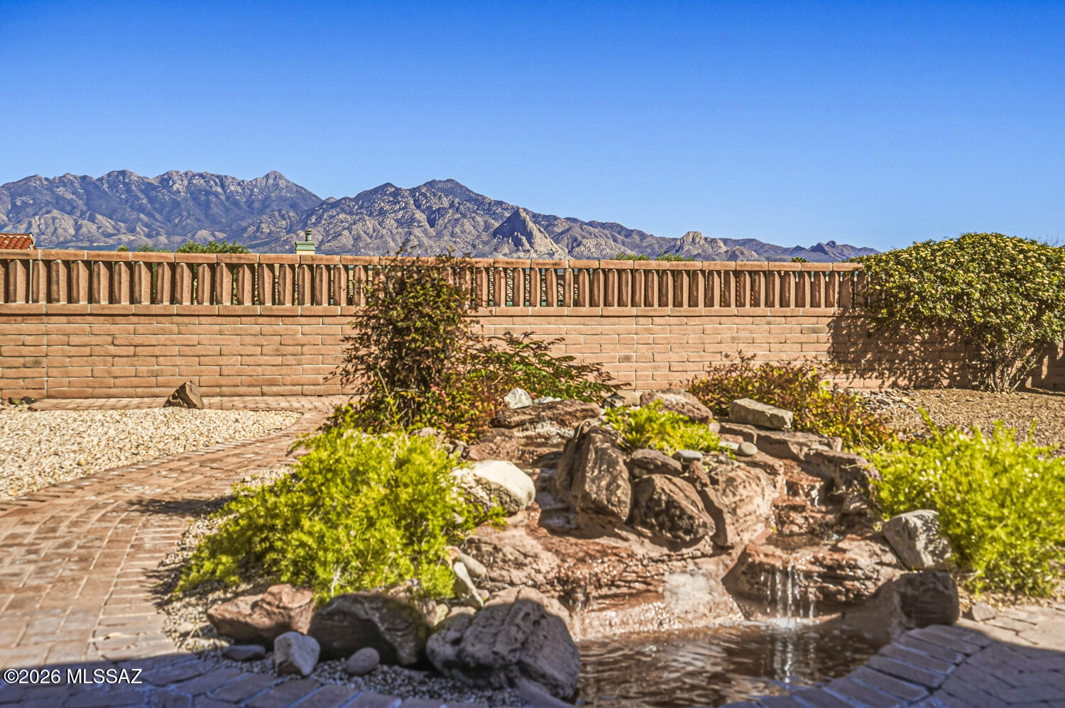 VIEWS, VIEWS, VIEWS! Stunning Mountain Views on a Premium Lot! This inviting open-concept home offers 2 bedrooms plus a versatile den and is perfectly situated on a premium lot showcasing breathtaking Santa Rita Mountain views. With 1,725 sq ft, fresh interior paint, and a newer roof (2020), the home feels bright and refreshed. The kitchen offers abundant cabinetry, a stainless steel refrigerator and large breakfast bar, flowing seamlessly into the main living areas, ideal for both everyday living and entertaining. The spacious owner's suite captures stunning mountain views and offers direct backyard access through sliding doors. The ensuite bath includes dual sinks, a garden tub, separate shower, and a walk-in closet. A flexible den with double doors and plantation shutters provides the perfect space for a studio, media room, or guest overflow. Step outside and take in the views, relax under the extended covered patio, enjoy the soothing sound of the fountain, and unwind among mature trees and desert landscaping in your own private retreat. The laundry room includes a utility sink and built-in desk, creating a practical and flexible home office space. Enjoy added efficiency and savings with a leased solar system. Ideally located just moments from San Ignacio Golf Club, this home offers easy access to early tee times and stunning sunset rounds. You're also minutes from Green Valley Recreation amenities, including pools, fitness centers, pickleball, art classes, and a wide variety of social activities within this desirable 55+ community.
