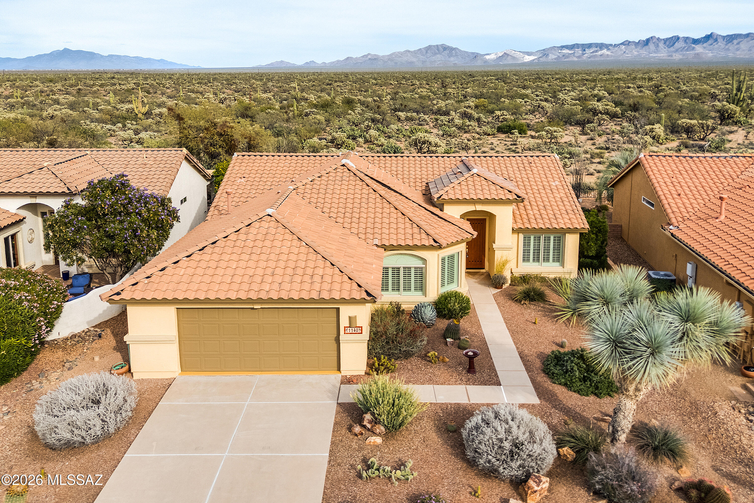 Location, Location! This meticulously maintained 2 BR, 2 BA Laredo model in the Quail Creek resort community offers outstanding privacy and truly spectacular views. Situated on a premium homesite backing to the 52,000-acre Santa Rita Experimental Range, this home captures unobstructed, panoramic desert and mountain vistas. Thoughtfully designed natural landscaping with native desert plants enhances the setting and blends seamlessly with the surrounding Sonoran beauty. Inside, the spacious great room features a custom built-in cabinet with retractable TV, in-ceiling speakers throughout the home, all tile flooring, and plantation shutters for a clean, timeless look. The kitchen is well-appointed with a center island, breakfast bar, gas range, and an expanded dining area with bay window. The expanded owner's suite showcases a bay window framing stunning desert and mountain views, while the main bath features dual vanities, a walk-in glass block shower, and a large walk-in closet with custom built-ins. A versatile den includes a built-in desk and wall bed, ideal for a home office or as an additional guest space. The guest bedroom offers a bay window overlooking the patio and open views. Outdoor living is extraordinary with a covered rear patio, custom stucco finish pergolas at each end, travertine pavers, and a built-in in-ground fire pit, perfect for enjoying peaceful Arizona sunrises and sunsets, bird watching, and observing neighboring wildlife. 
 
Move-in ready and beautifully refreshed with new interior paint throughout, creating a bright, clean, and modern feel. Recent updates include a new roof (2024) and new HVAC (December 2025). With the big-ticket improvements already completed, this home is truly turnkey and ready for its next owner. Just bring your furniture and enjoy the view!