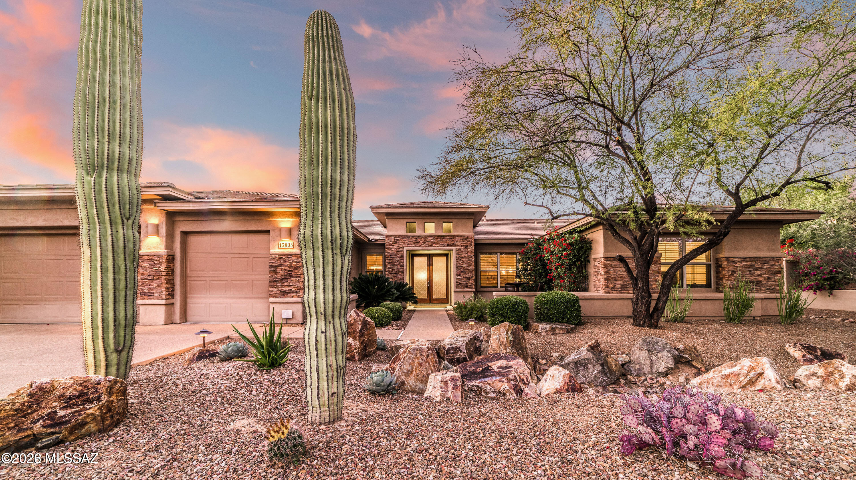 This stunning Pepper Viner-built former model is located in a prestigious, gated enclave of Rancho Vistoso and epitomizes Oro Valley luxury living. Offering a desirable split 4-bedroom, 3-bath floor plan plus den/playroom, this home is rich with custom upgrades and exquisite detail throughout.
The gourmet kitchen is a chef's dream, featuring granite slab countertops, custom cabinetry, and premium stainless-steel appliances including a Sub-Zero refrigerator, Wolf cooktop and oven, Viking warming drawer, and KitchenAid dishwasher. The kitchen opens seamlessly to the inviting family room, highlighted by a dramatic custom stone fireplace with a mesquite mantel sourced from the Tumacácori Mesquite Sawmill.
Warm neutral ceramic tile flows throughout the main living areas, with plush carpet...