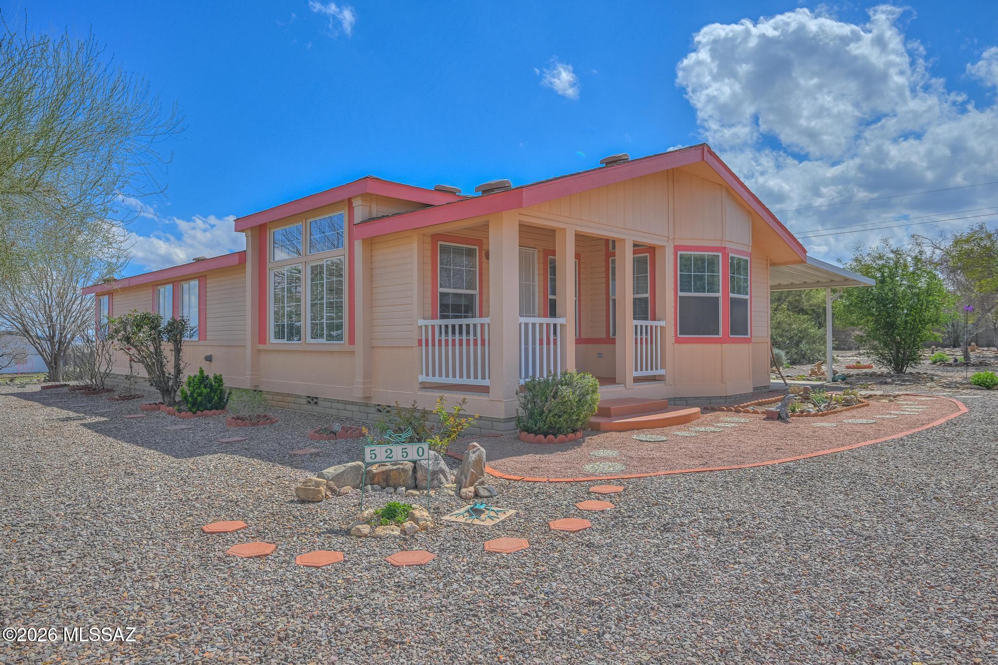 Well-maintained 3BR/2BA manufactured home on a beautifully landscaped .83-acre lot with stunning mountain views in Hereford! This 1,392 sq. ft. home features numerous updates including gorgeous luxury vinyl flooring (2025) and a new AC (2025) for year-round comfort. The spacious primary suite offers a garden tub, separate shower, and walk-in closet. Enjoy dual pane windows, many upgrades throughout, and a comfortable layout for everyday living. Relax outside on the covered patio and take in the scenery. Property includes a detached 2-car garage and plenty of outdoor space. A fantastic opportunity for country living with room to breathe! Peaceful country feel while still just minutes from shopping, restaurants, and Ft. Huachuca.