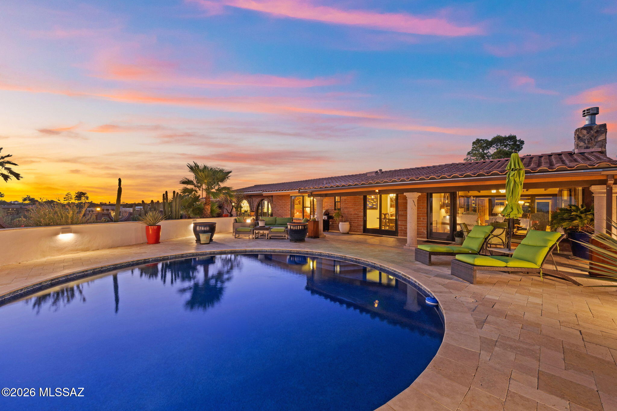 Perched high atop a private hill behind a gated entrance, this beautifully updated 1958 burnt adobe home offers breathtaking city and mountain views. Thoughtfully remodeled with no expense spared, this 3 bedroom, 3 bathroom residence blends timeless character with modern comfort. Enjoy Arizona living at its finest from the inviting pool and outdoor living spaces designed to capture the spectacular scenery. Inside, you'll find spacious bedrooms, raised beamed ceilings, a warm living room with a wood-burning fireplace, formal dining room, breakfast area, and a versatile bonus room that's perfect for entertaining. The kitchen is highlighted by a stunning 9-burner gas range, making it ideal for everyday living and special gatherings. Located in the heart of the Catalina Foothills.