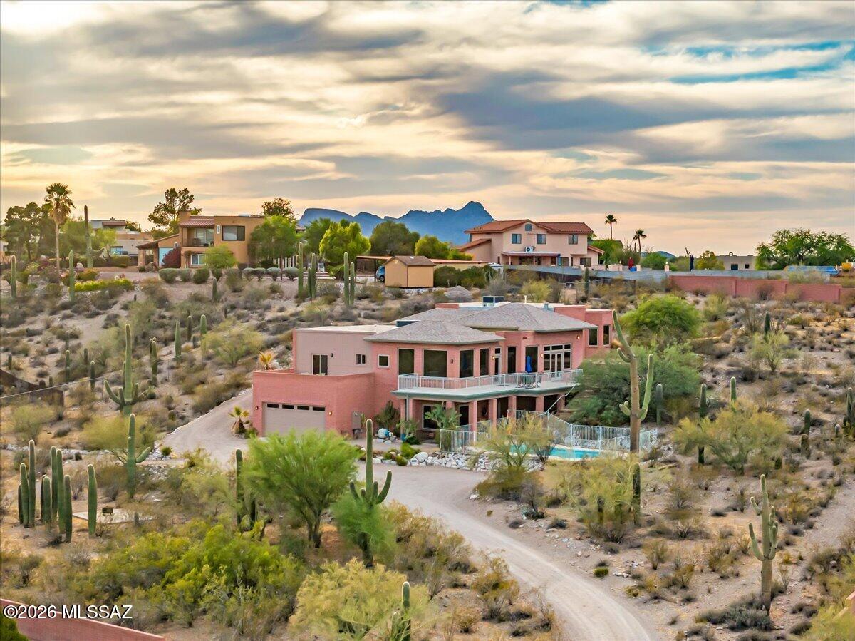 Welcome to one of Tucson's most extraordinary equestrian properties, privately nestled on the highly coveted west side and embraced by towering saguaros, this remarkable sanctuary commands sweeping mountain and city vistas from nearly every window.

This stunning contemporary, 4 bedroom, 4.5 bath main home is only minutes from downtown. Located at the end of the road, this gated & fully fenced 2.9 acre property includes a multi-level main house, pool, large garage/workshop & a totally separate horse facility with guest quarters.  Step inside to discover a natural light filled open floor plan with breathtaking panoramic views through all new oversized windows and doors. Retreat to the secluded primary suite with its own private patio, surrounded by amazing views & lush desert landscape. Relax on the deck overlooking the sparkling pool, set just outside the huge lower level game room with its own full bath.

The 5 stall horse barn is absolutely beautiful. Each stall has its own lockable tack storage area, large turnouts & riding arena.
The barn also features a charming studio with a full bathroom and kitchen and a large 2nd floor area that can be configured as rental income, additional living quarters, exercise room, office, etc. Nearby trails to Sweetwater preserve!

This is truly an irreplaceable retreat, and a rare tribute to the enduring majesty of the Sonoran Desert.