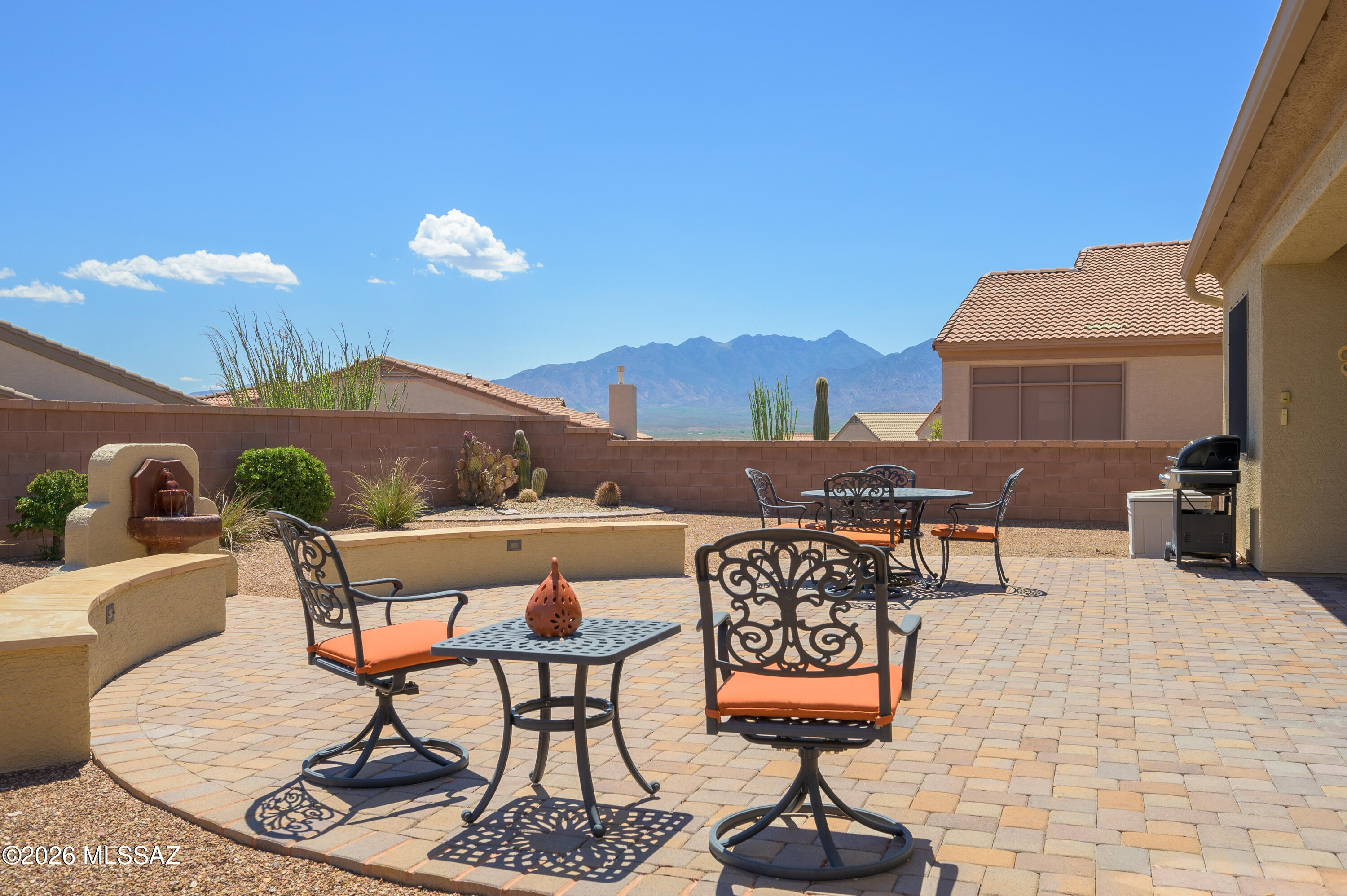 Experience Arizona living at its finest in this stunning 2 BD + den, 2 BA home featuring lovely Santa Rita Mountain views, an incredible backyard designed for entertaining & a rare 3-car garage. High ceilings & a flowing floor plan showcase beautiful travertine floors, granite counters, rich cabinetry & SS appliances. The spacious kitchen offers abundant prep space, extensive storage & opens seamlessly to the living & dining areas. Thoughtfully designed with exceptional storage throughout, this home blends comfort & functionality. Retreat to the spacious primary suite featuring a convenient roll-in shower. Enjoy outdoor living on the expansive covered patio while taking in mountain views. Ideally located near community amenities in Green Valley's sought-after 55+ GVR community.