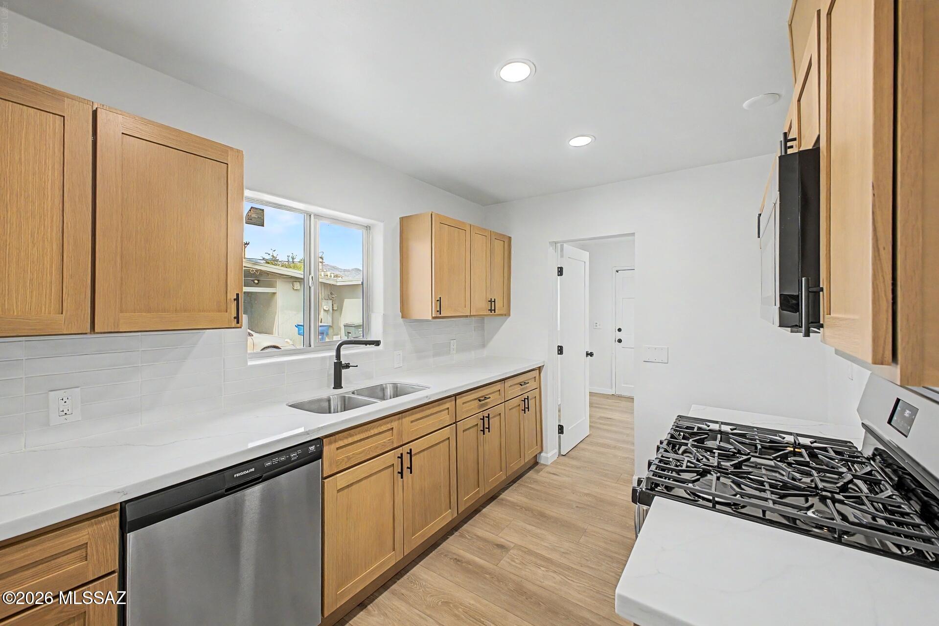 Move-in ready single-family home featuring a large detached garage at the rear of the property--ideal for extra storage, parking, or a workshop! Enjoy a super convenient central location close to abundant shopping, dining, entertainment, and everyday amenities. The interior has been beautifully refreshed with luxury plank flooring, plush carpet in the bedrooms, modern lighting and plumbing fixtures, Quartz countertops, fresh interior and exterior paint, stainless steel appliances, natural finish cabinetry, stylish tile shower surrounds, new windows, and more. A fantastic opportunity for move-in-ready living in a central location. A must see!
