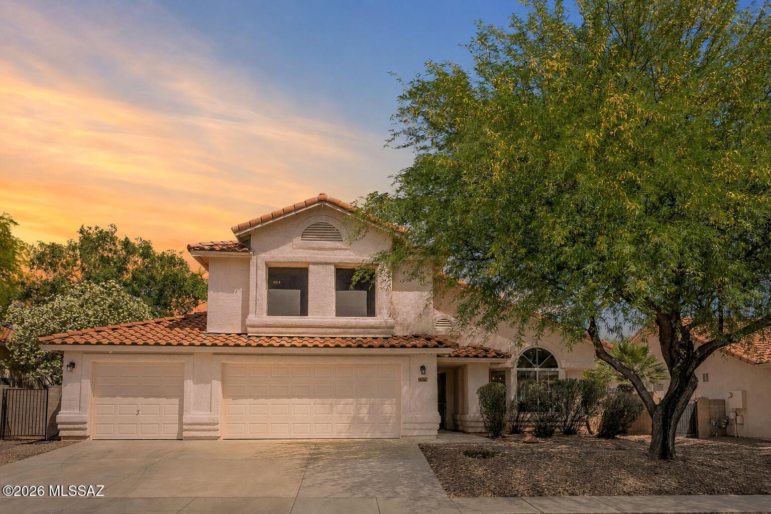 Built for a full house! Cake on the patio, being silly at the playground, and in the pool by 2. The downstairs suite rivals the primary with its own backyard entry for a multigenerational option. With 5 bedrooms, 3 full remodeled baths, there is room for everyone. The updated kitchen is ready for gatherings, with granite counters and custom California Closets pantry. Morning coffee comes with Catalina Mountain views from the primary suite balcony. The roof and HVAC were replaced in recent years so you don't have to. The 3 car garage includes epoxy flooring, an EV charger, and plenty of room for gear, tools, and toys. This is the kind of home where people gather, grow, and make memories for years to come! VA Assumable, 5.75% rate, call for details.