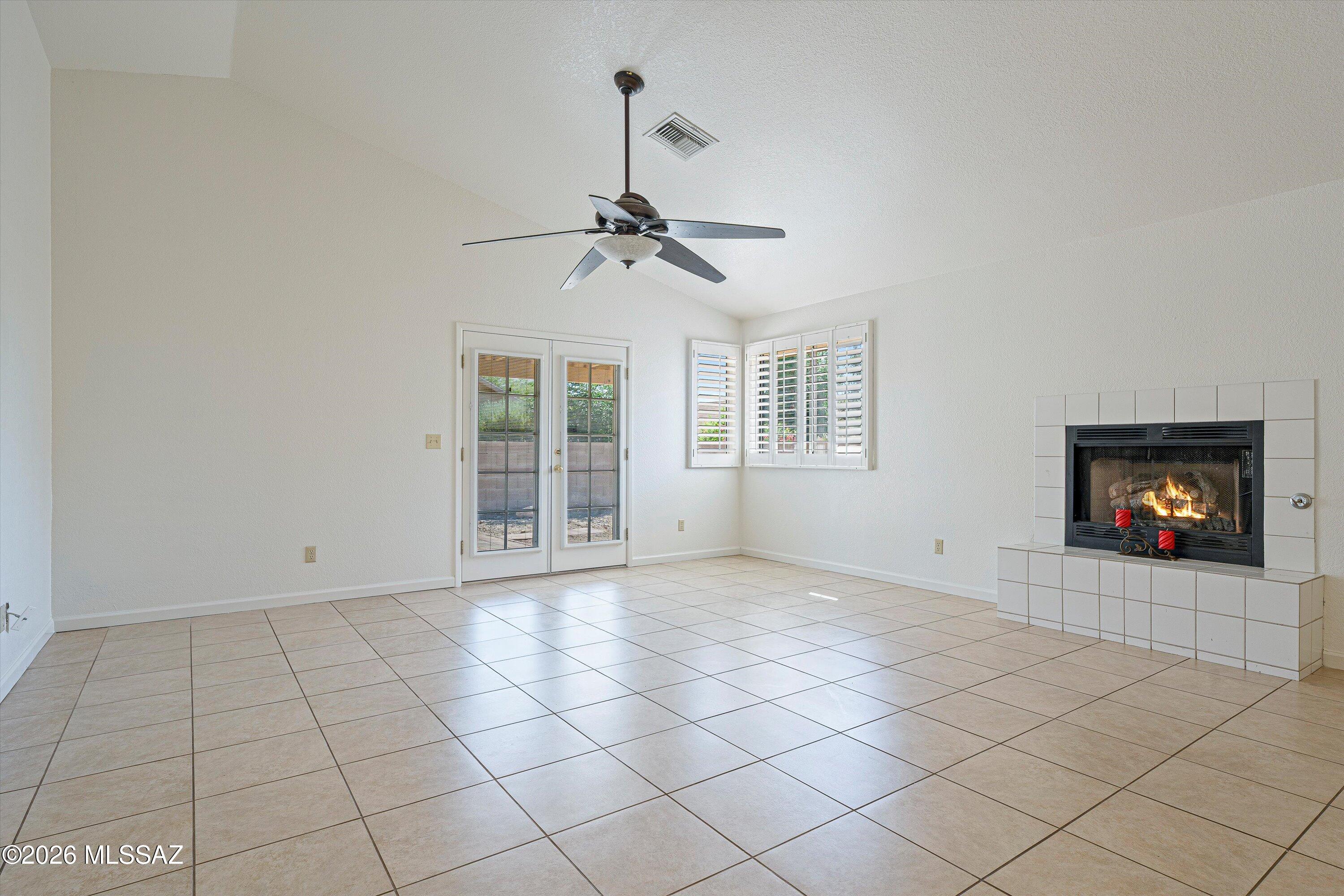 Move-in ready 2 bedroom plus den home with a 2-car garage in a convenient location near Speedway and Greasewood. This well-maintained property features tile flooring throughout most of the home, with carpet in the spacious primary bedroom. The primary bath offers a custom tile shower, double vanity, and walk-in closet. Vaulted ceilings and abundant natural light create an open, inviting feel, while the great room includes a gas fireplace and French door leading to the covered patio. Kitchen includes stainless steel appliances, and the home also features a water softener, plantation shutters and fresh interior paint. Major updates include a new A/C in 2024 and roof replacement in 2025. Close to shopping, restaurants, Pima Community College West, and Downtown Tucson.