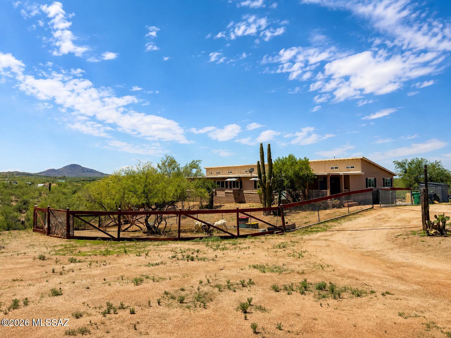 You've arrived! Welcome to your new home nestled in the picturesque foothills of the Rincon Mountains. Driving in you'll pass through National public land through which the Arizona Hiking Trail crosses, should you feel inclined to walk to Canada or Mexico! At 3,100 ft elevation, this home enjoys four seasons, light snows in the winter, and temperatures that average 10 degrees lower than the valley.

This home boasts 5 acres of diverse terrain, with ample space for livestock or a hobby farm. This charming Southwestern style single story home has 4 bedrooms, 2 full bathrooms, a brand new front porch, and a screened in back balcony (added in 2024) that spans one side of the house. With an additional bonus room to spare, three walk-in closets, custom Saltillo floors in the salon and dining rooms, custom tile floors in both bathrooms, luxury vinyl wood flooring throughout the rest of the house all added in 2022, and looming 10.5ft tall ceilings across the pitched portion of the house, complete with custom automatic blinds on all the clearstory windows, as well as a thoughtful layout, this home is a tastefully renovated must see for anyone desiring unrestricted land just 20 min from central Vail, 30 min from downtown Tucson, with some of the most breathtaking sunsets and impeccable views available, without X-9 Ranch prices, replete with an unusually lush desert landscape and wildlife.

Between 2024-2026, the homeowner has also added: a large entry wall with a wide 16ft opening and space for a security door at the front of the property, repaired and replaced chain link fencing around the house with extra doors for easy access to the rest of the property, a back patio, storage shed, large repaired pre-existing shed that has been converted into a generous sized fenced in chicken coop, two working and electrified corrals, multiple roundabouts and an additional road that runs the entire interior border of the 5 acres, with extra walking trails and a private wash to boot! The home also had a new roof added in 2022, new insulation underneath, flex sealing over the ductwork, consistent termite treatments since 2022, additional support beams added beneath to suit all your heavy furnishing needs, an additional staircase to the raised balcony in the backyard, which is fully fenced in, beautiful appliances added in 2022, custom blinds, shade sails to shelter your vehicles, and last but certainly not least, new electrical panels, lots of extra flooring material for future repairs, two greenhouses, a private well with proven ample water depth! a new water tank and well pump. Don't miss your opportunity to own this truly unique, gorgeous, and rare find off the beaten path, but within easy driving distance to some of Arizona's very finest schools, dining, and shopping.