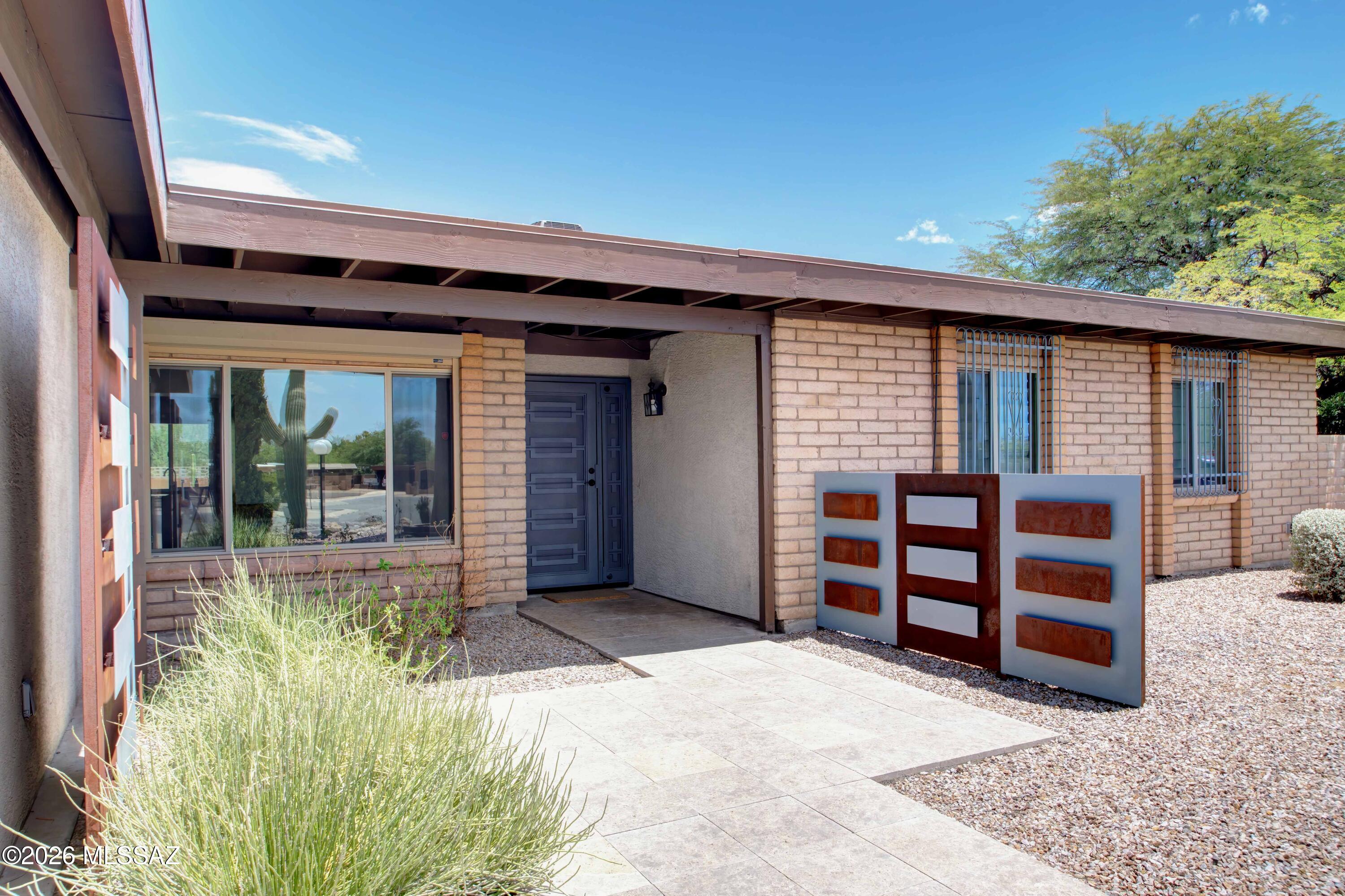 Discover this beautifully updated 3-bed/ 3-bath home nestled in a quiet, established SW Tucson neighborhood. Conveniently located near shopping, dining, entertainment, with easy access to I-19. Inside find modern updates throughout, including a stylish kitchen, renovated bathrooms, & a versatile bonus room that can serve as a family room or office space. Thoughtfully designed floor plan features two primary suites, providing flexible living options or added privacy. Many custom features have to be seen to believe. Step outside to your private backyard oasis, with mountain views. Landscaped outdoor space designed to relax & entertain, featuring sparkling pool & covered ramada enhanced by distinctive metal work. Enjoy Tucson sunsets from the comfort of your own backyard retreat.
