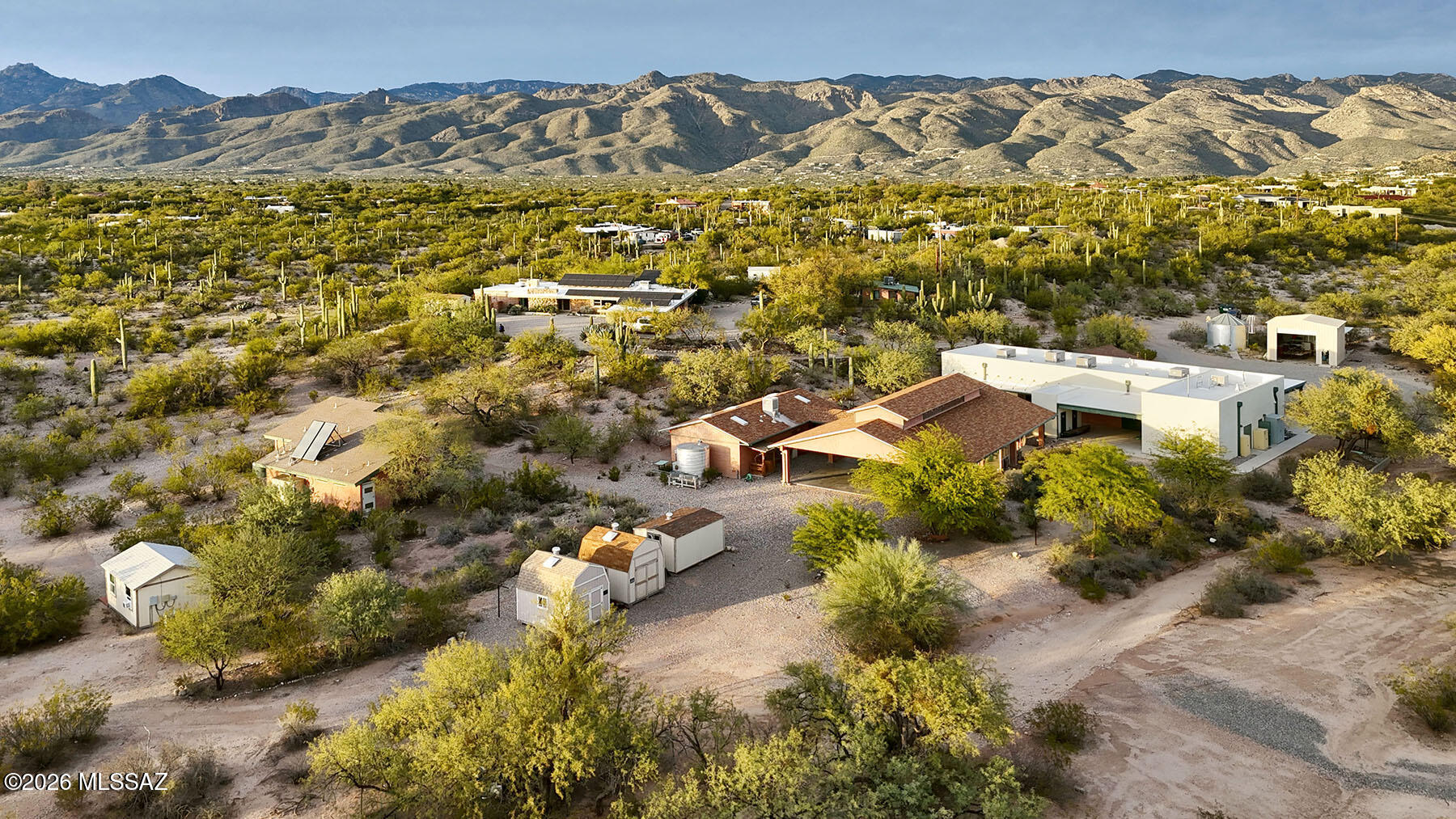 Located in Northeast Tucson at 2751 N. Soldier Trail, this 10.5-acre property offers a rare opportunity to acquire a purpose-built campus well suited for outdoor education, experiential learning, retreat use, or mission-driven institutional ownership. Formerly operated as a national outdoor education facility, the property combines functional improvements with a private desert setting ideal for group programming and training.The site is zoned Suburban Ranch (SR) and features multiple improvements totaling over 7,000 square feet, including two residential-style buildings, a large open-air ramada constructed in a barn-style architectural form, and additional support structures.
