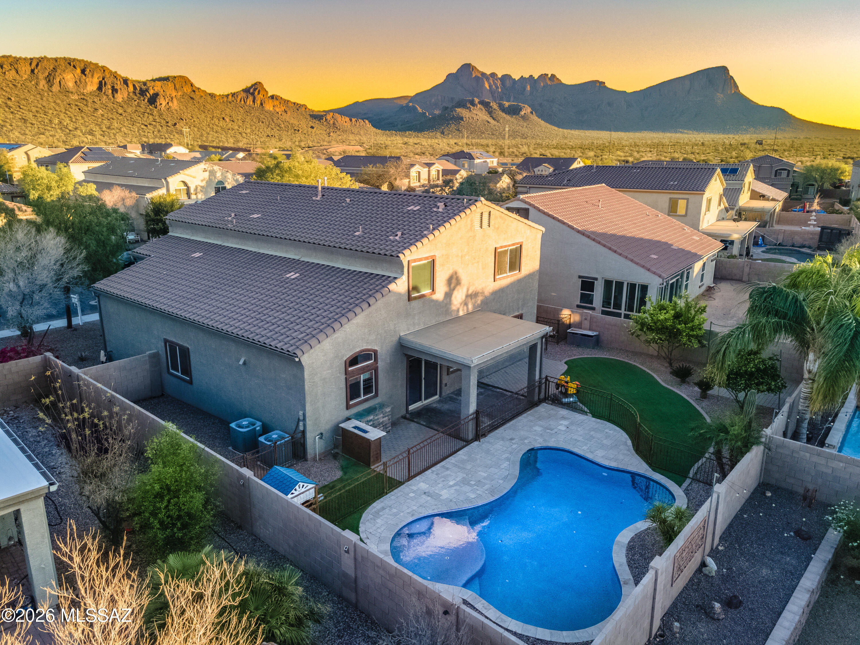 Welcome to this beautiful two-story Ventana model in desirable Saguaro Springs featuring 4 bedrooms and 3 bathrooms. This well-maintained home offers a grand entry with a custom built office and elegant staircase. The chef's kitchen includes a gas cooktop, double ovens, upgraded staggered cabinets, granite countertops, large island and pantry, opening to a spacious living room with wood wall accents. A bedroom and full bath are conveniently located on the main floor. Upstairs features the primary suite with large walk-in closet, spacious loft, two additional bedrooms and bath. The backyard is a private oasis with covered patio, built-in gas fireplace, PebbleTec pool with in-floor cleaning, travertine decking, turf and lush landscaping. Seller will pay off solar at closing. Must See!