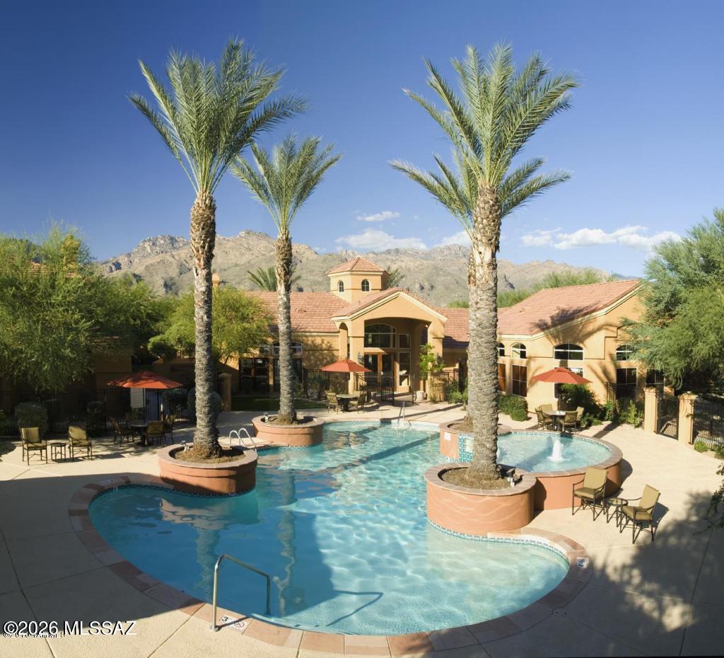 This charming corner unit condo offers 2 bedrooms, 2 full bathrooms, upgraded soft-close cabinetry, a cozy fireplace in the living room and Saltillo tile throughout. The kitchen includes granite counter tops, LG dishwasher, LG refrigerator, LG electric cooktop, Roper washer and dryer. A covered parking space and 1-car garage with electric door opener are both a few steps away. The private patio is accessible from both the dining room and main bedroom and offers breathtaking views of the beautiful Catalina Mountains. For your enjoyment, you will have access to a heated swimming pool and spa, an exercise facility, a recreation room for entertaining and electric vehicle charging stations.